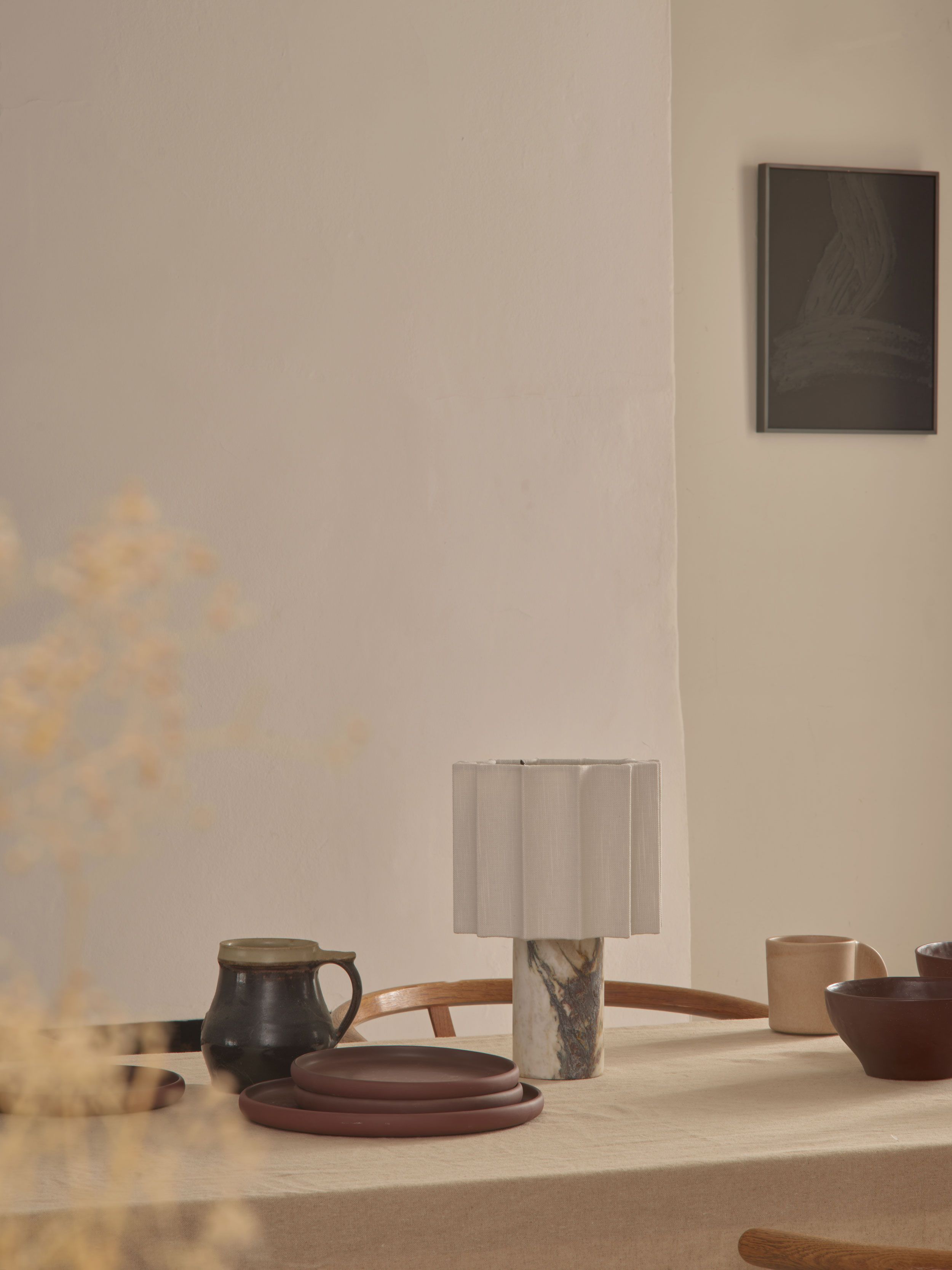 Image may contain: Lamp, Indoors, Interior Design, Table Lamp, Pottery, Furniture, Table, and Dining Table