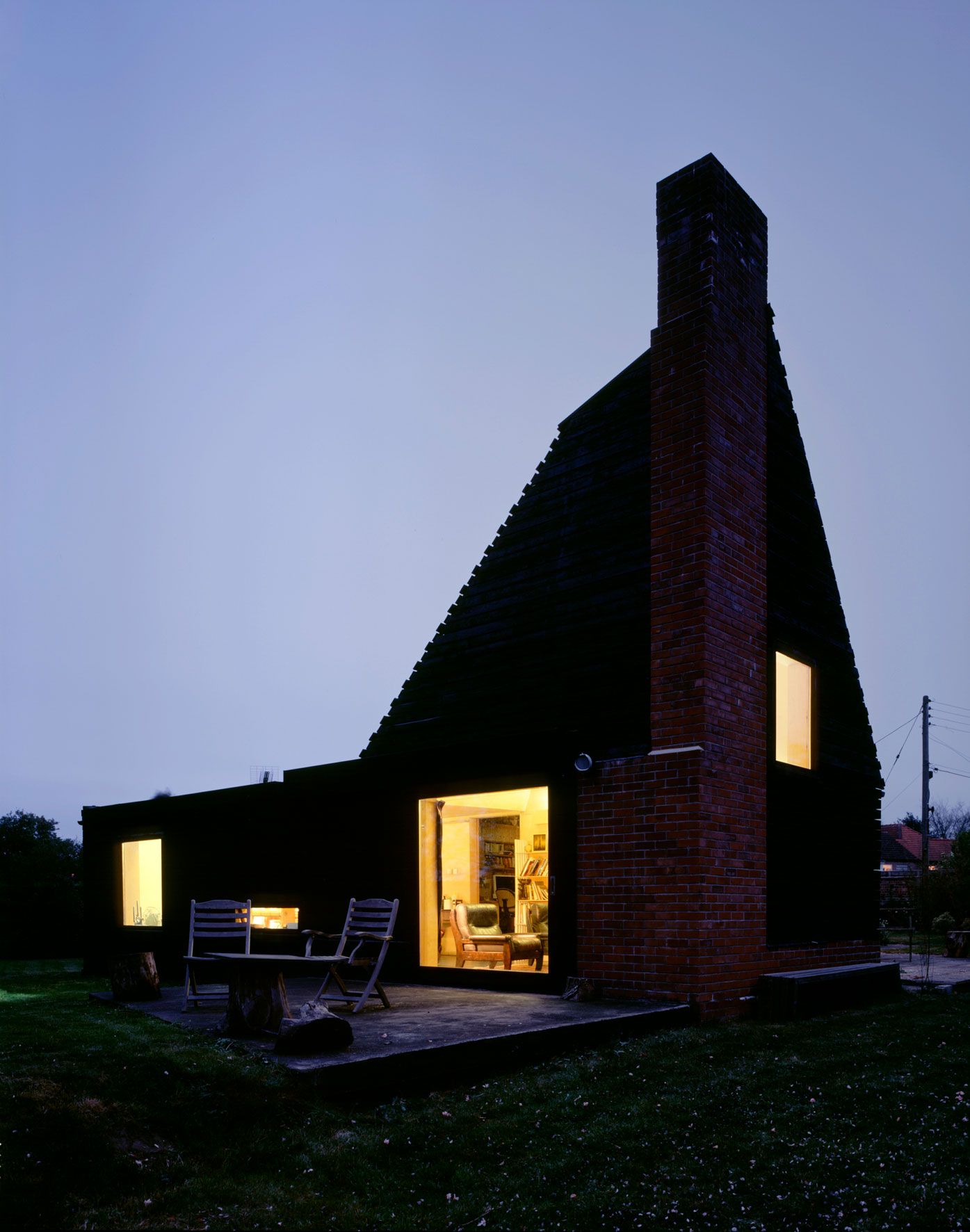 Image may contain: Architecture, Building, Cottage, House, Housing, Outdoors, Shelter, Grass, Plant, Chair, and Furniture