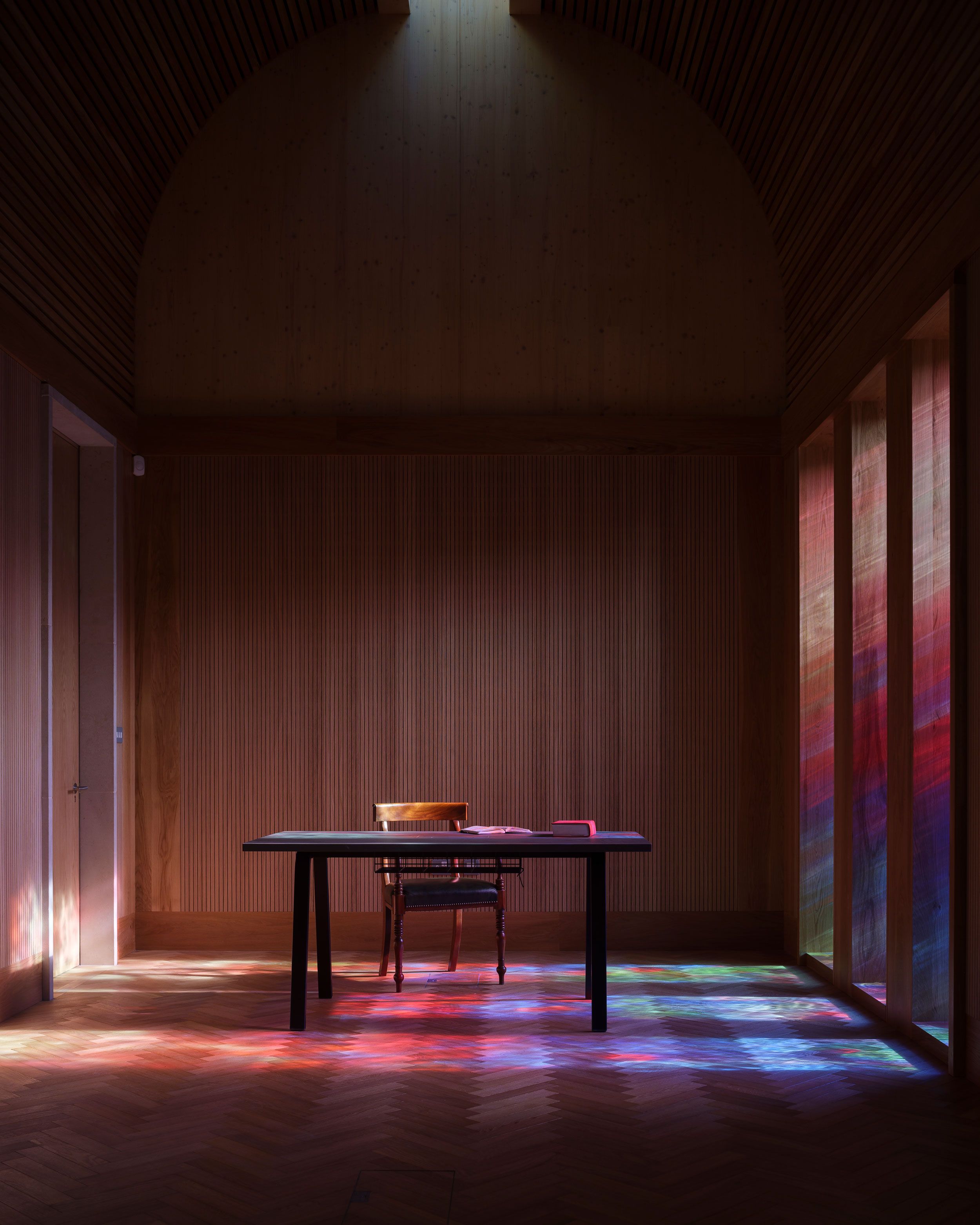 Image may contain: Indoors, Interior Design, Floor, Lighting, Chair, Furniture, Flooring, Desk, Table, Performer, and Person