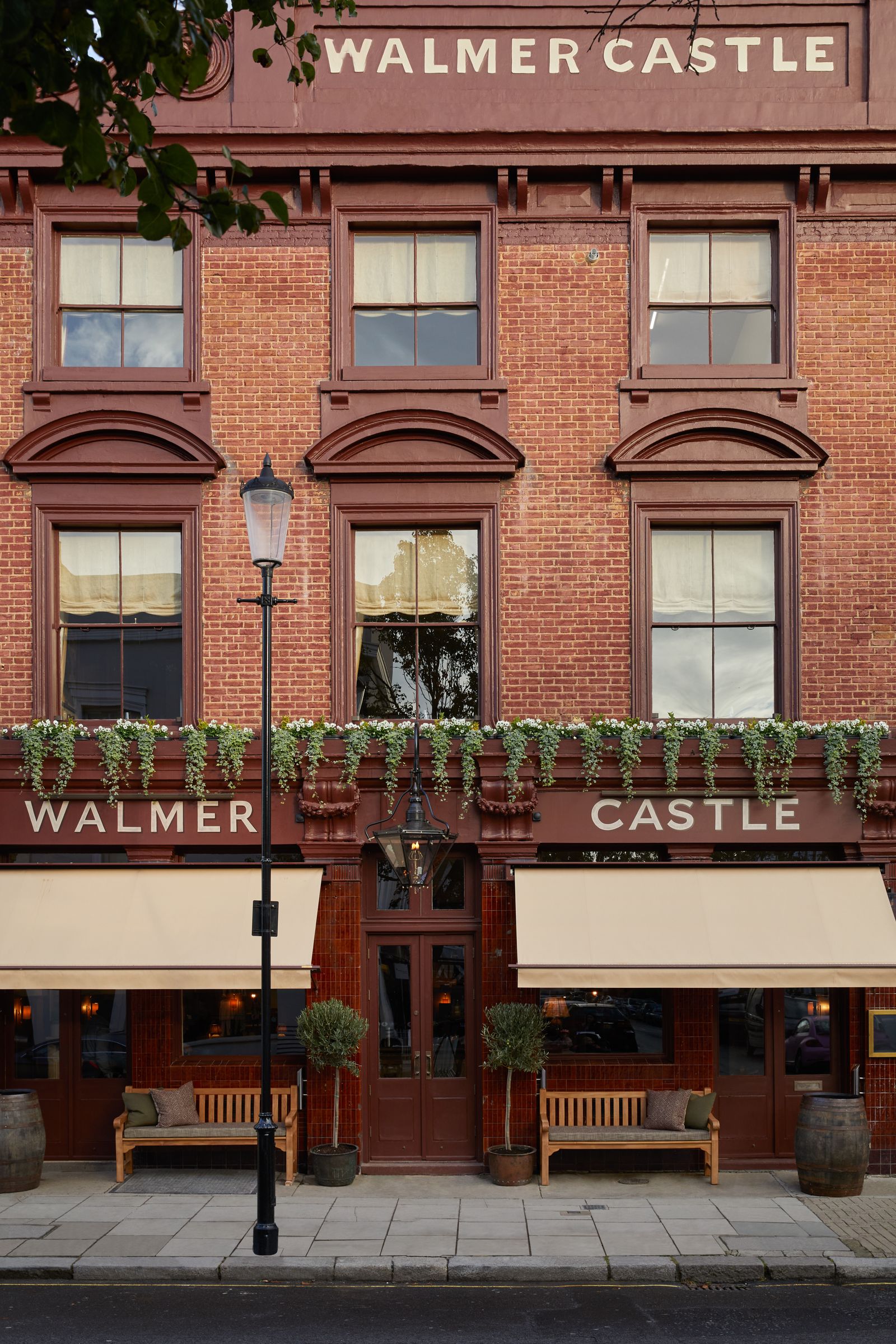 Image may contain Plant Bench Furniture City Brick Urban Car Transportation Vehicle and Canopy