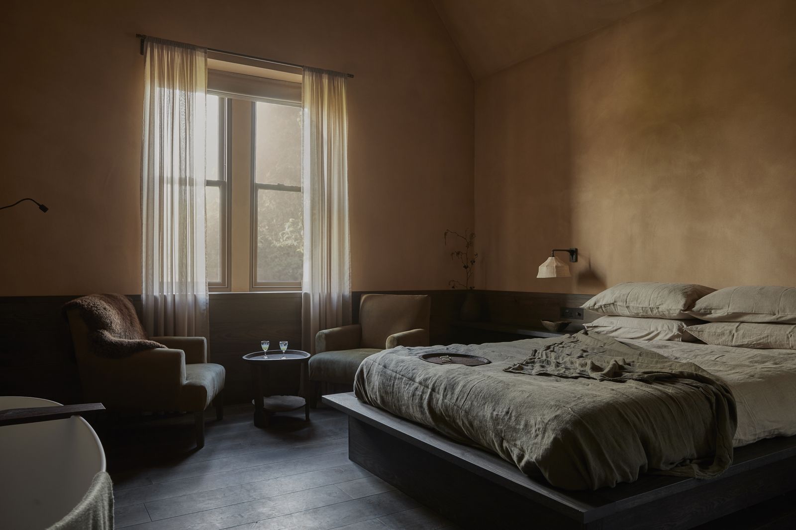 Image may contain Indoors Interior Design Home Decor Bed Furniture Chair Lamp Bedroom Room Cushion and Cup