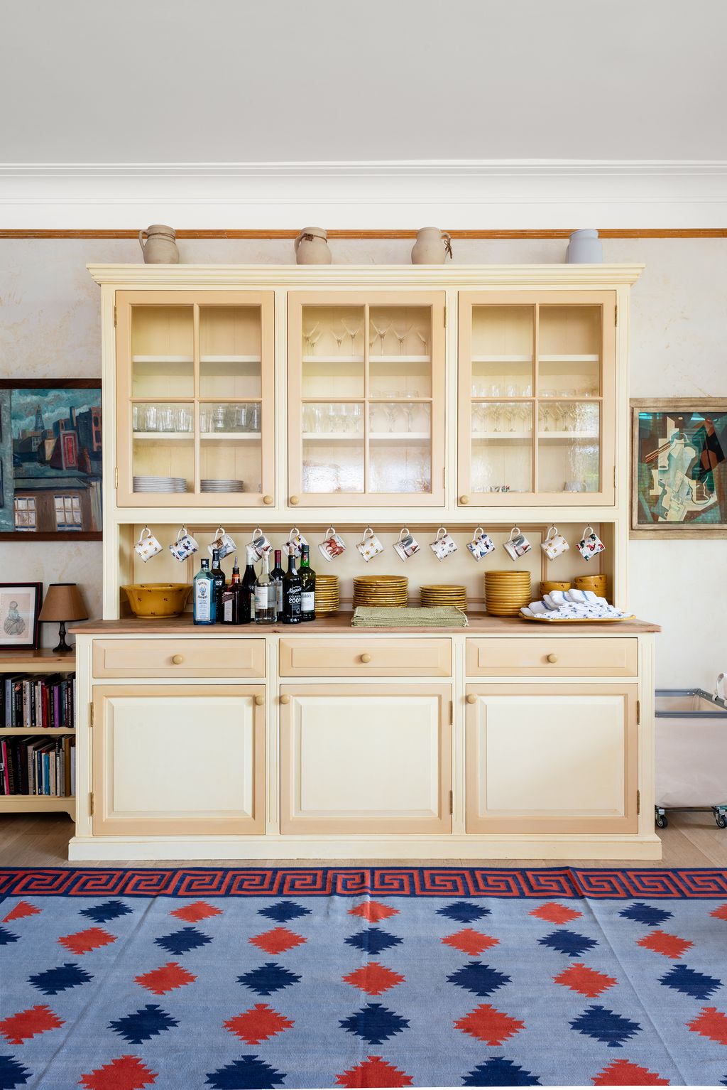 Image may contain Home Decor Lamp Rug Indoors Interior Design Furniture Sideboard Cabinet Shelf Cup and Closet