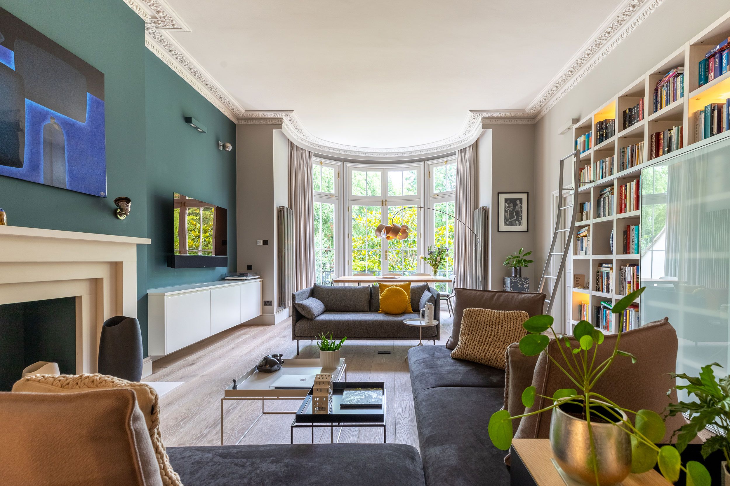 Image may contain: Home Decor, Plant, Art, Painting, Couch, Furniture, Architecture, Building, Indoors, Living Room, and Room