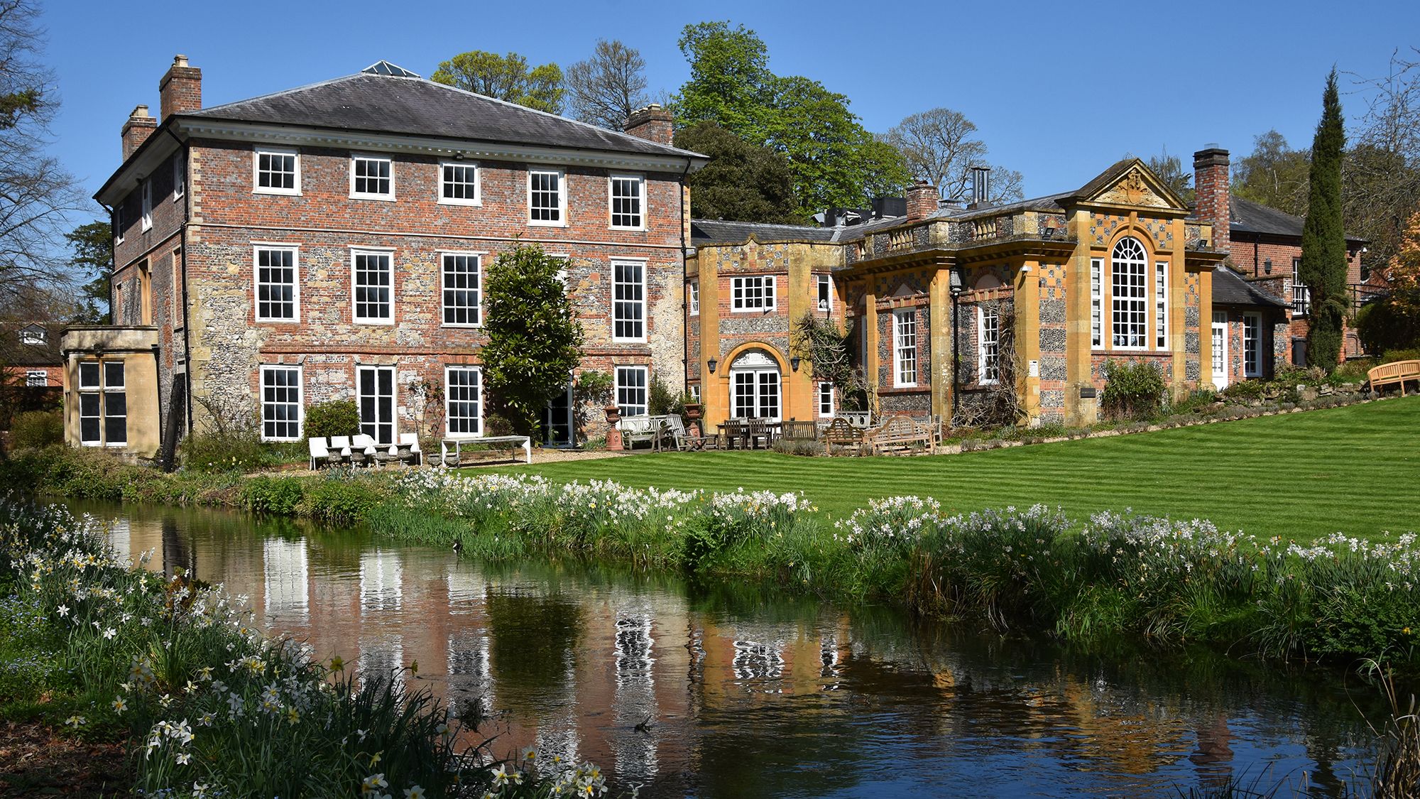 Image may contain: Architecture, Building, Housing, Nature, Outdoors, Pond, Water, House, Manor, Bench, and Furniture