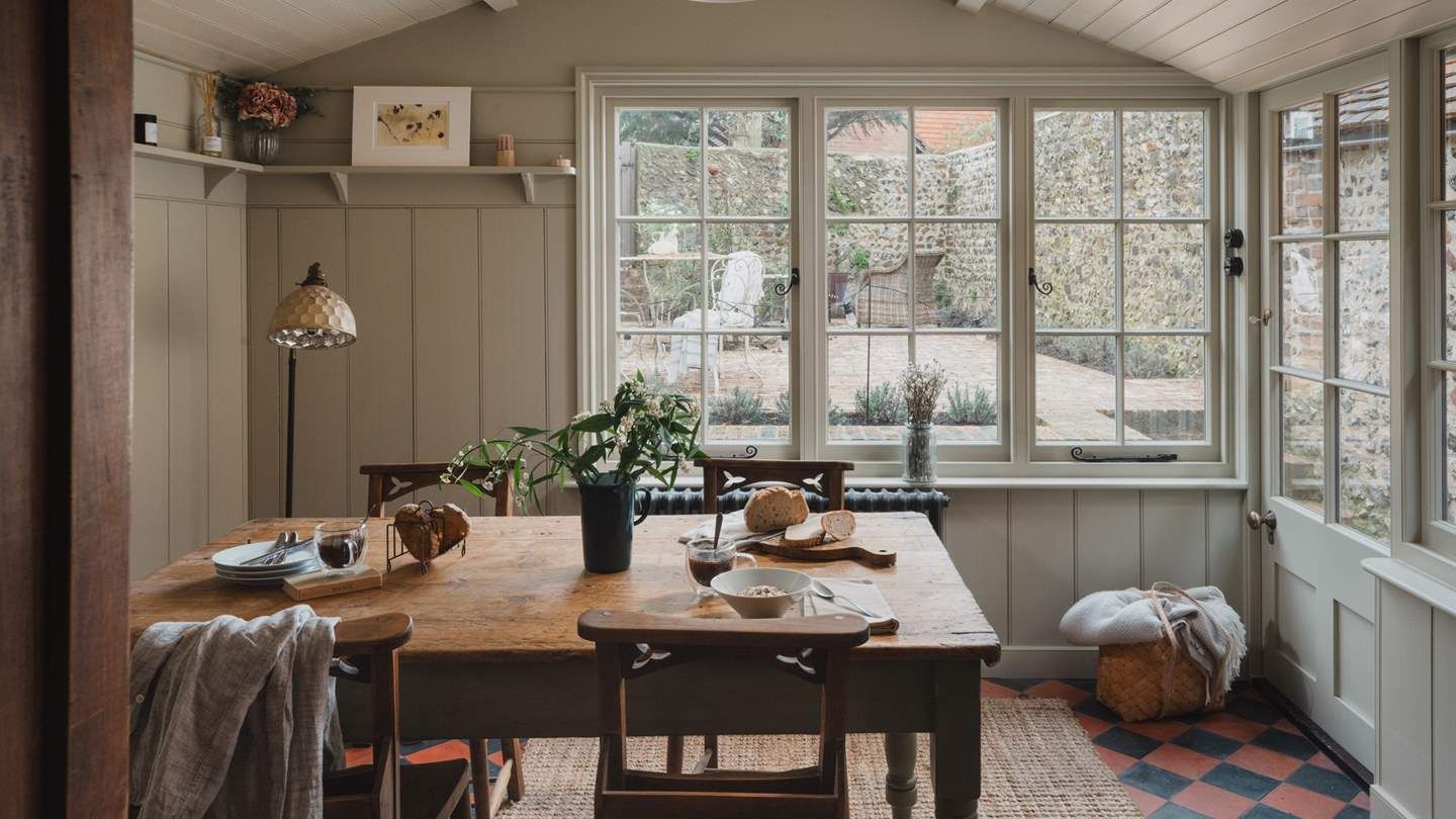 Image may contain Furniture Table Architecture Building Dining Room Dining Table Indoors Room Window and Lamp