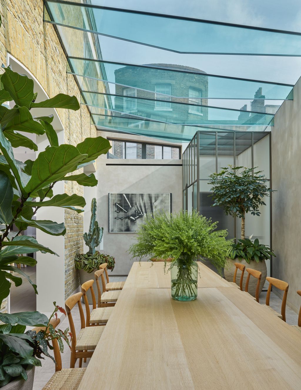 Image may contain Indoors Interior Design Plant Dining Table Furniture Table Desk Chair Floor and Tabletop