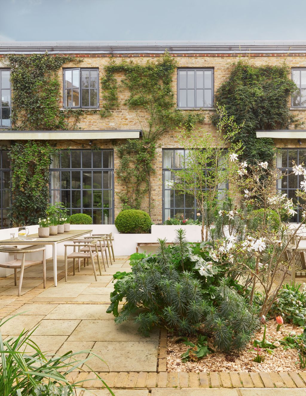 Image may contain Desk Furniture Table City Plant Chair Architecture Building Housing Door Urban and House