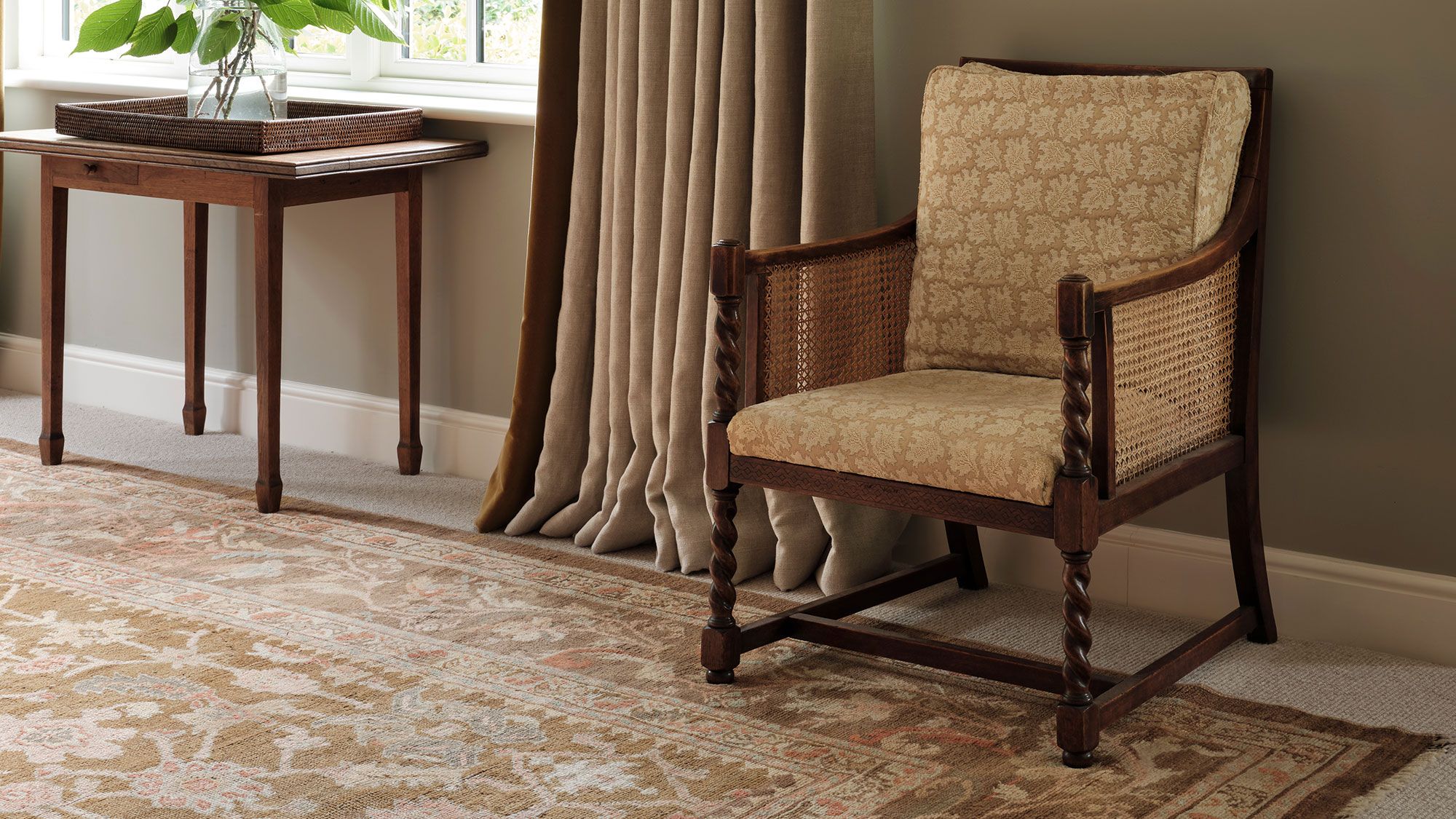 Image may contain: Home Decor, Rug, Chair, Furniture, Floor, Plant, and Armchair