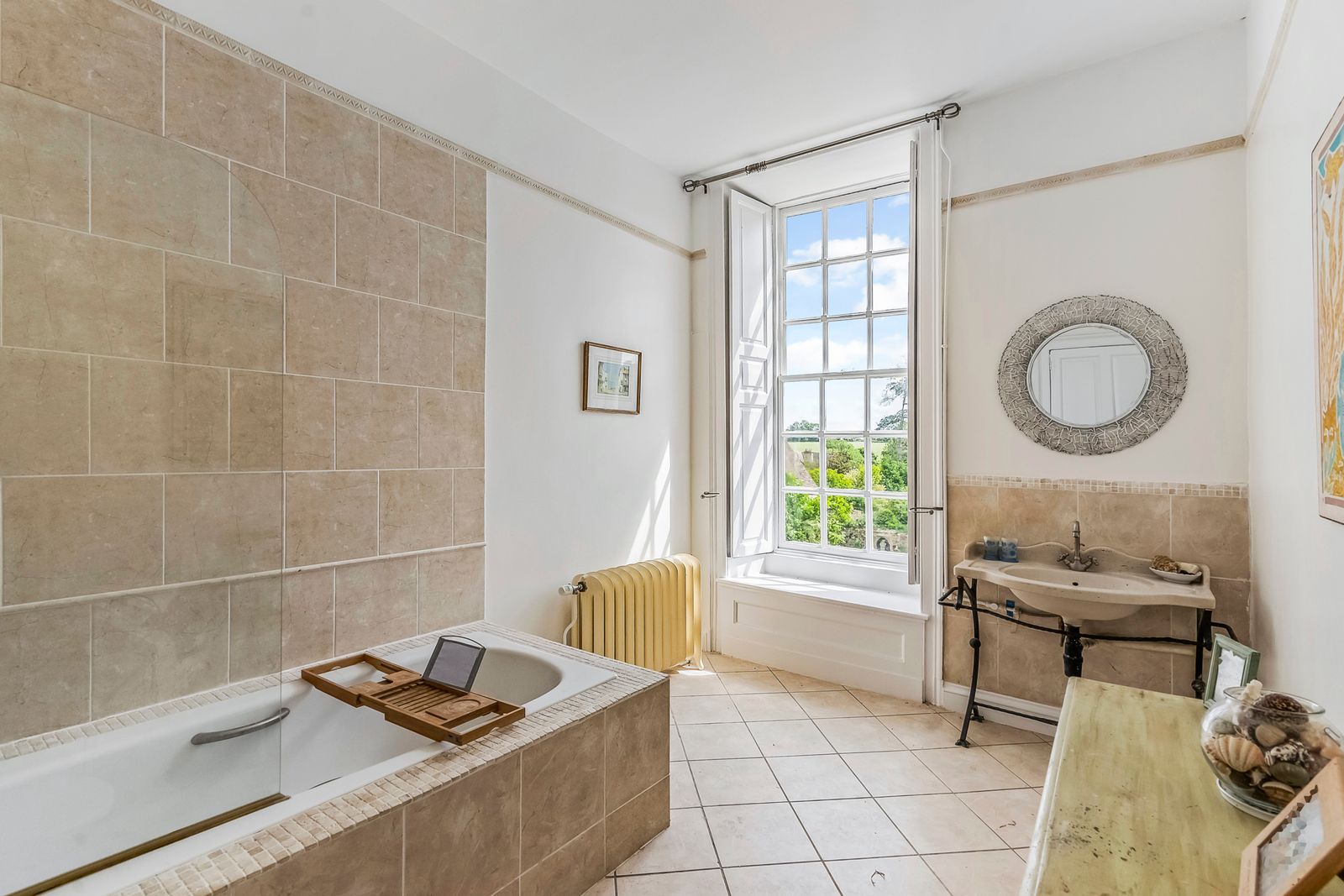 Image may contain Bathing Indoors Interior Design Bathtub Person Tub Desk Furniture Table Sink and Sink Faucet