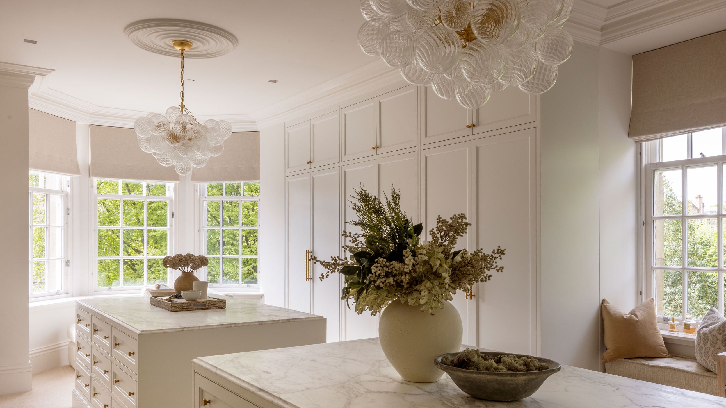 Image may contain: Chandelier, Lamp, Window, Indoors, Interior Design, and Bay Window