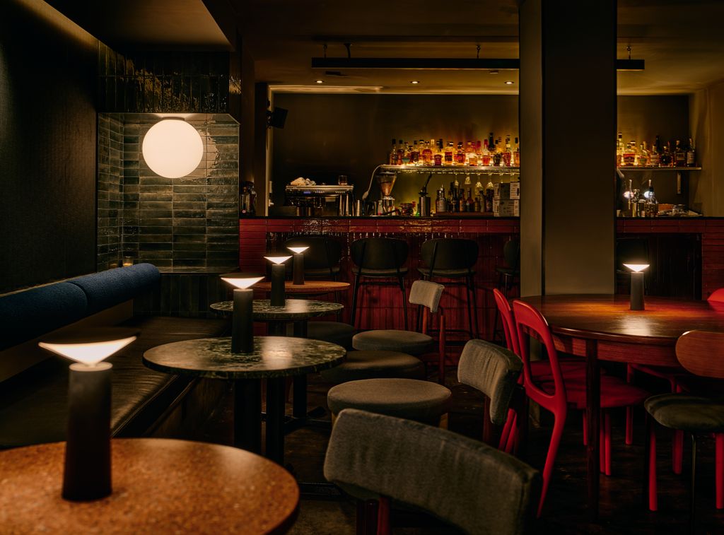 Image may contain Chair Furniture Bar Desk Table Lamp Candle Electronics and Speaker