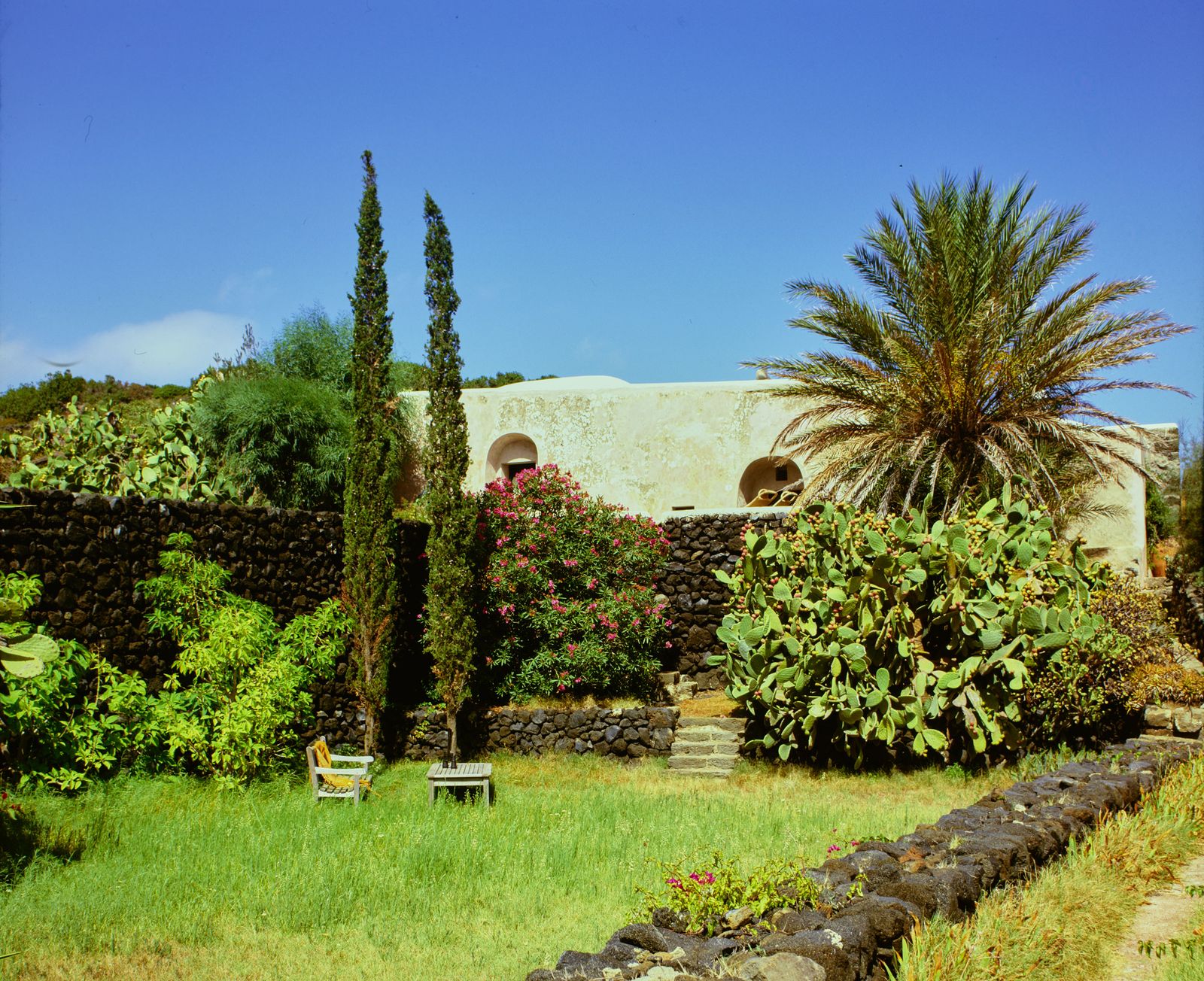 Image may contain Architecture Building House Housing Villa Grass Plant Tree Garden Nature Outdoors and Hacienda