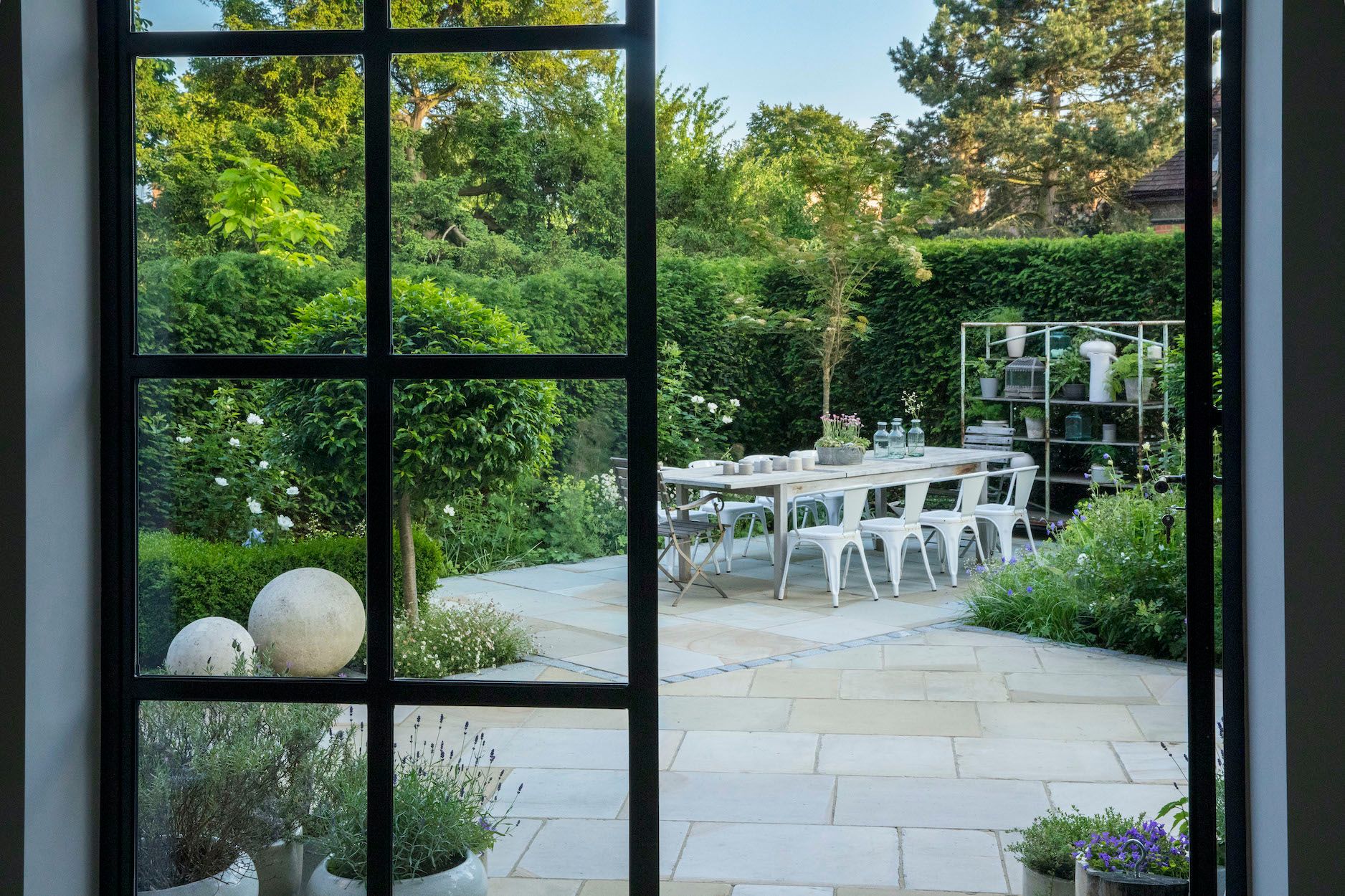 Image may contain: Indoors, Interior Design, Plant, Door, Garden, Nature, Outdoors, French Window, Window, and Floor