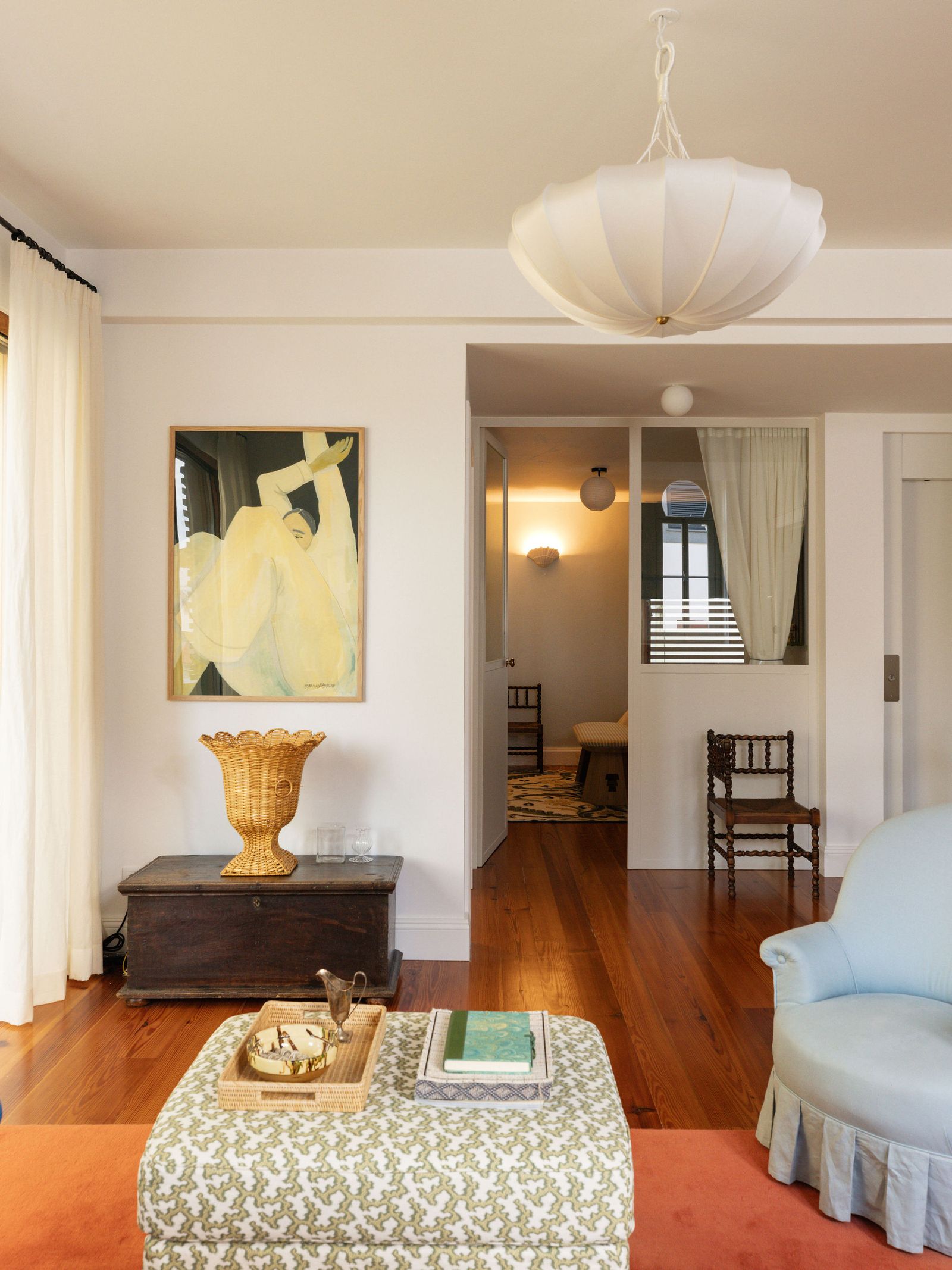 Image may contain Chair Furniture Lamp Home Decor Rug Art Painting Architecture Building Indoors and Living Room