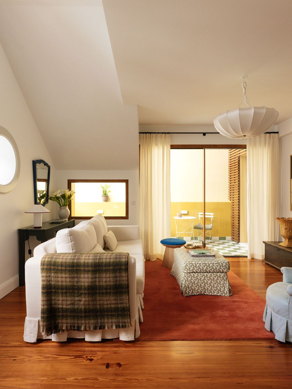 Image may contain Home Decor Lamp Plant Chair Furniture Couch Desk Table Indoors Interior Design and Rug