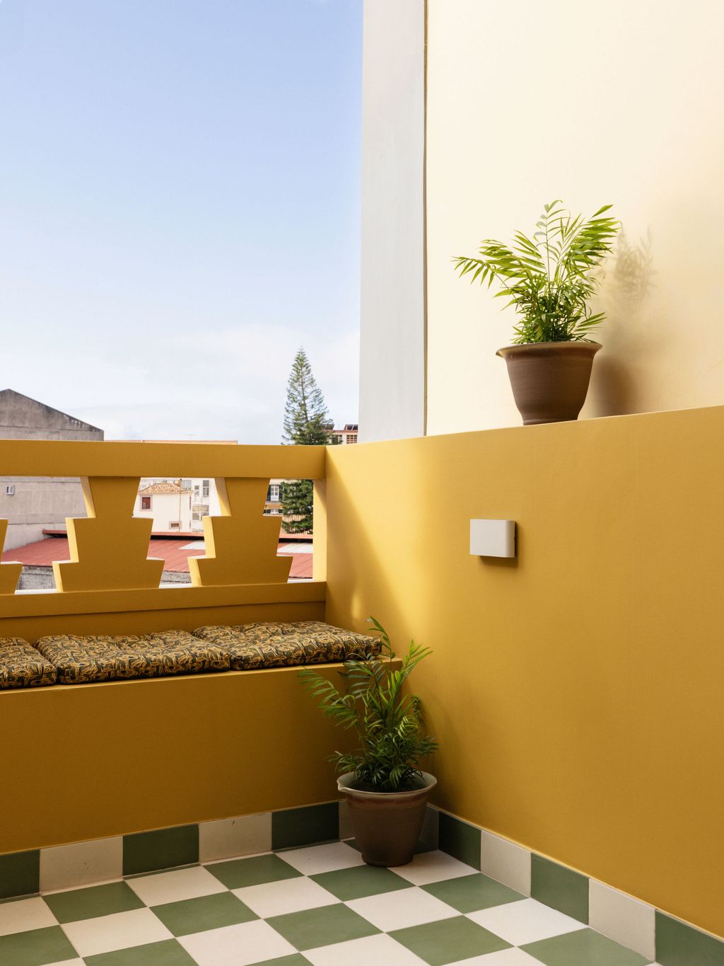 Image may contain Architecture Balcony Building Plant Potted Plant Bench Furniture Jar Planter Pottery and Vase