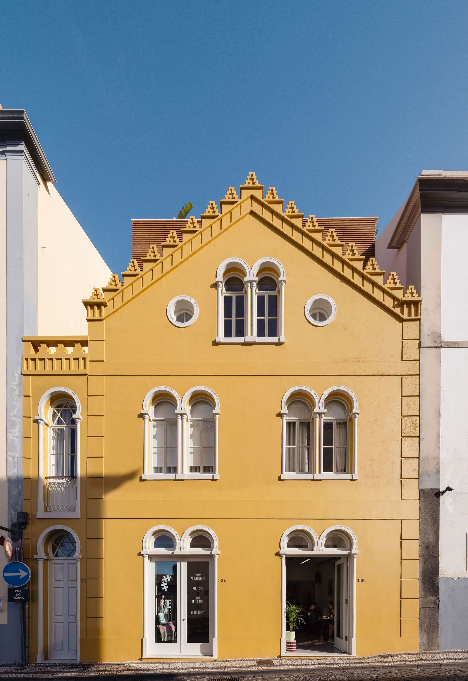 Image may contain Arch Architecture Gothic Arch Plant French Window Window Person City Building and Housing