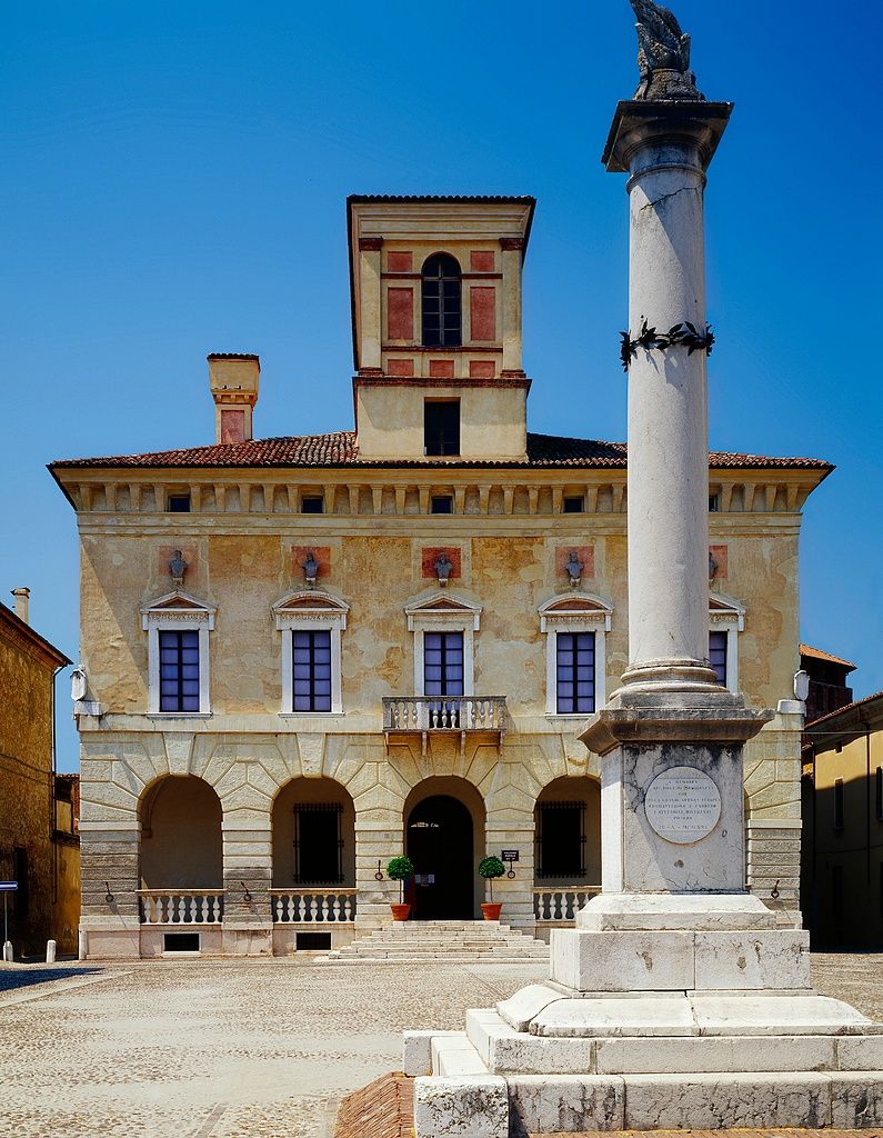 Image may contain Architecture Building House Housing Villa Plant Arch Portico Gothic Arch and Person