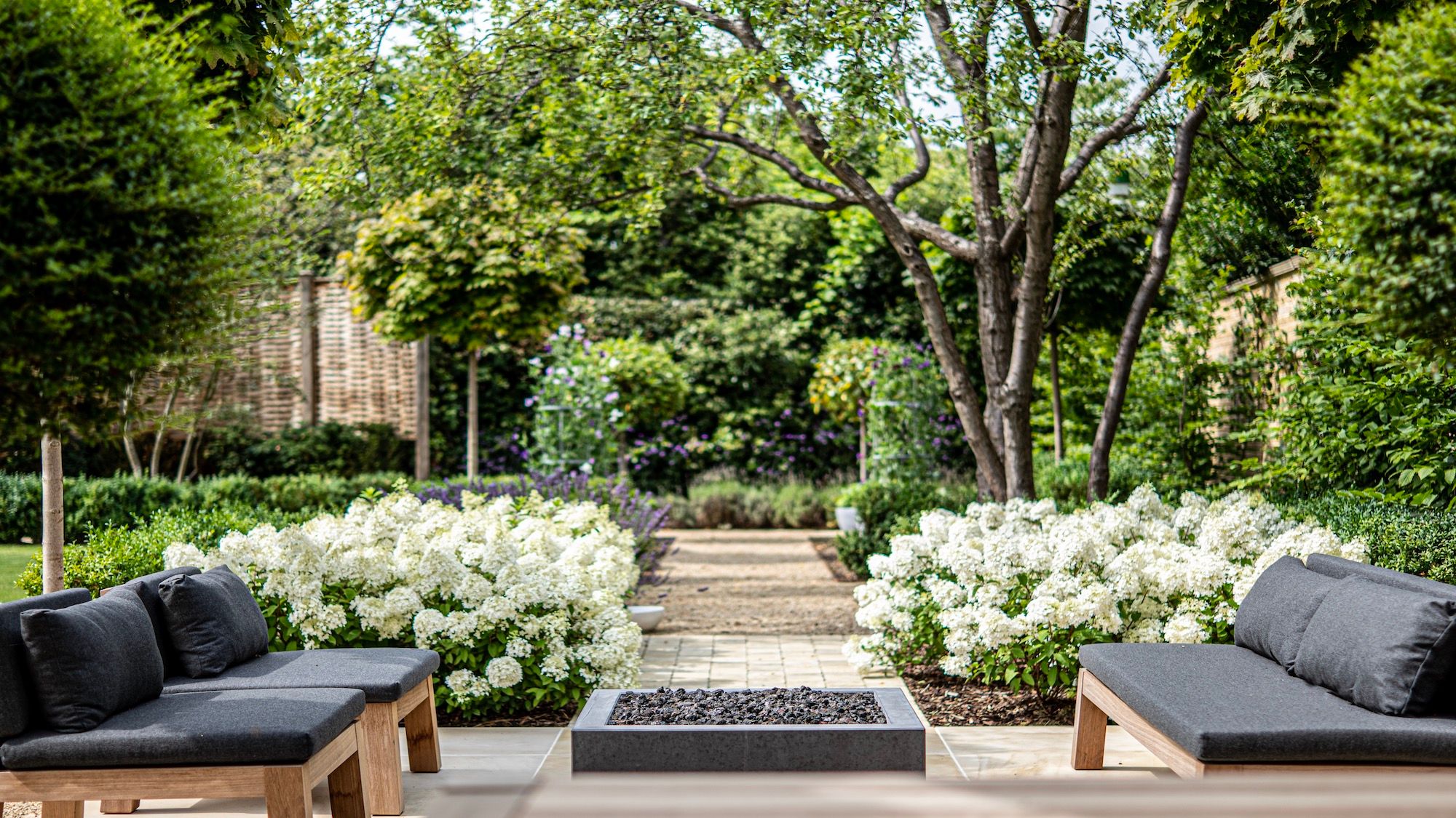 Image may contain: Backyard, Nature, Outdoors, Yard, Grass, Park, Plant, Garden, Couch, Furniture, Vegetation, and Home Decor