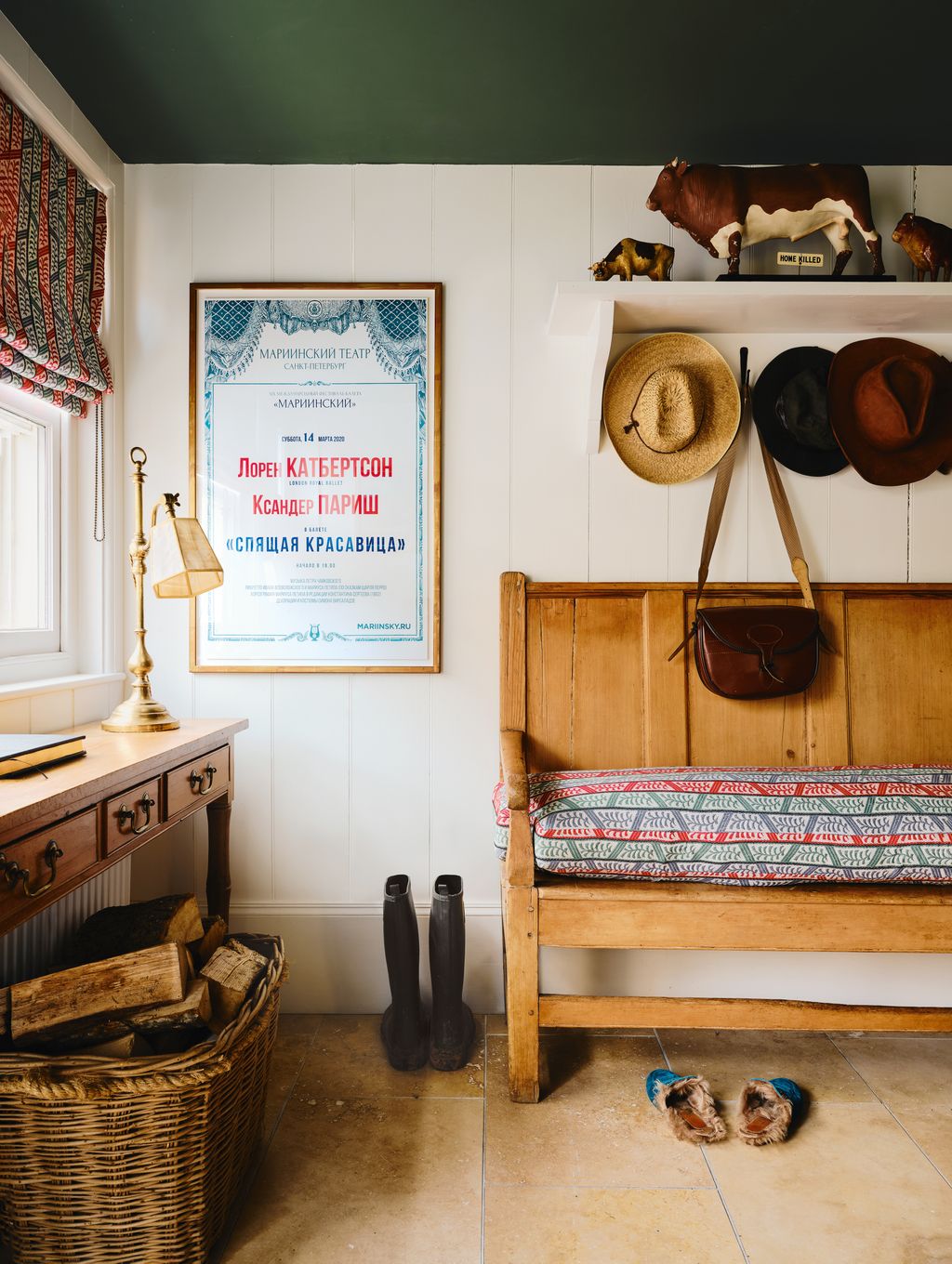 Image may contain Indoors Interior Design Lamp Clothing Hat Wood Accessories Bag Handbag Floor Animal and Cattle