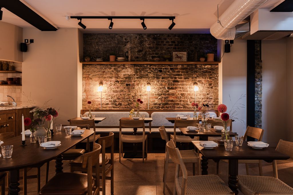 Image may contain Architecture Building Dining Room Dining Table Furniture Indoors Room Table Restaurant and Cup