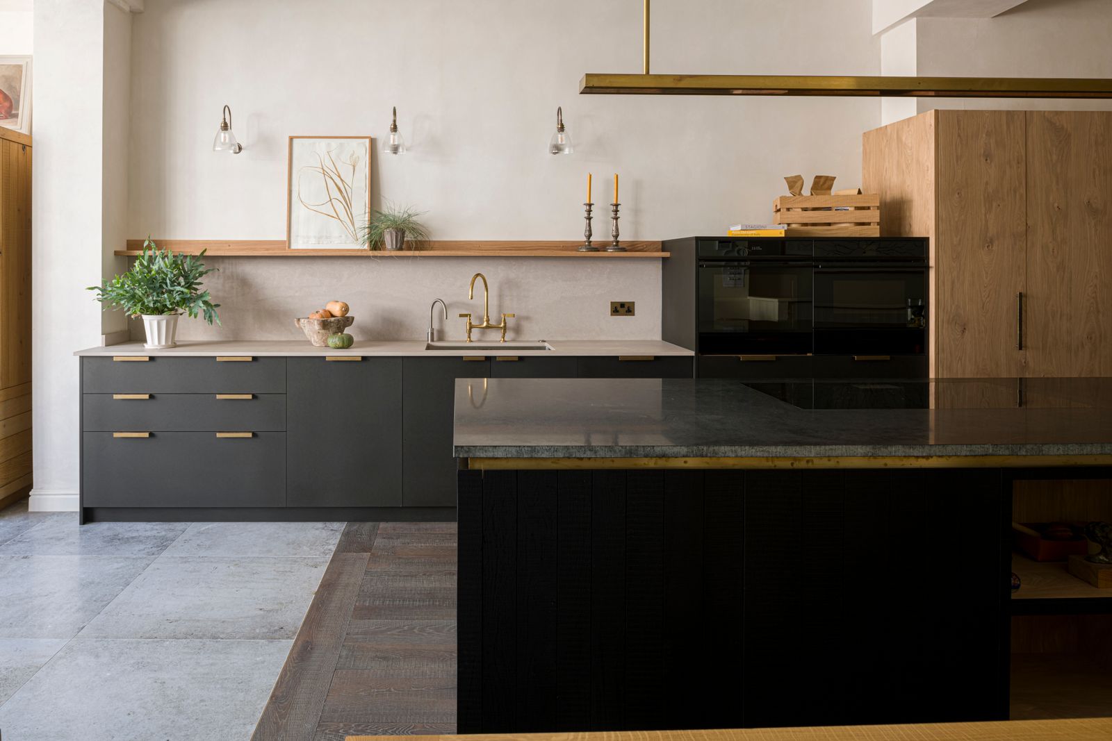 Image may contain Indoors Interior Design Kitchen Plant Sink Sink Faucet Kitchen Island Lamp Cabinet and Furniture