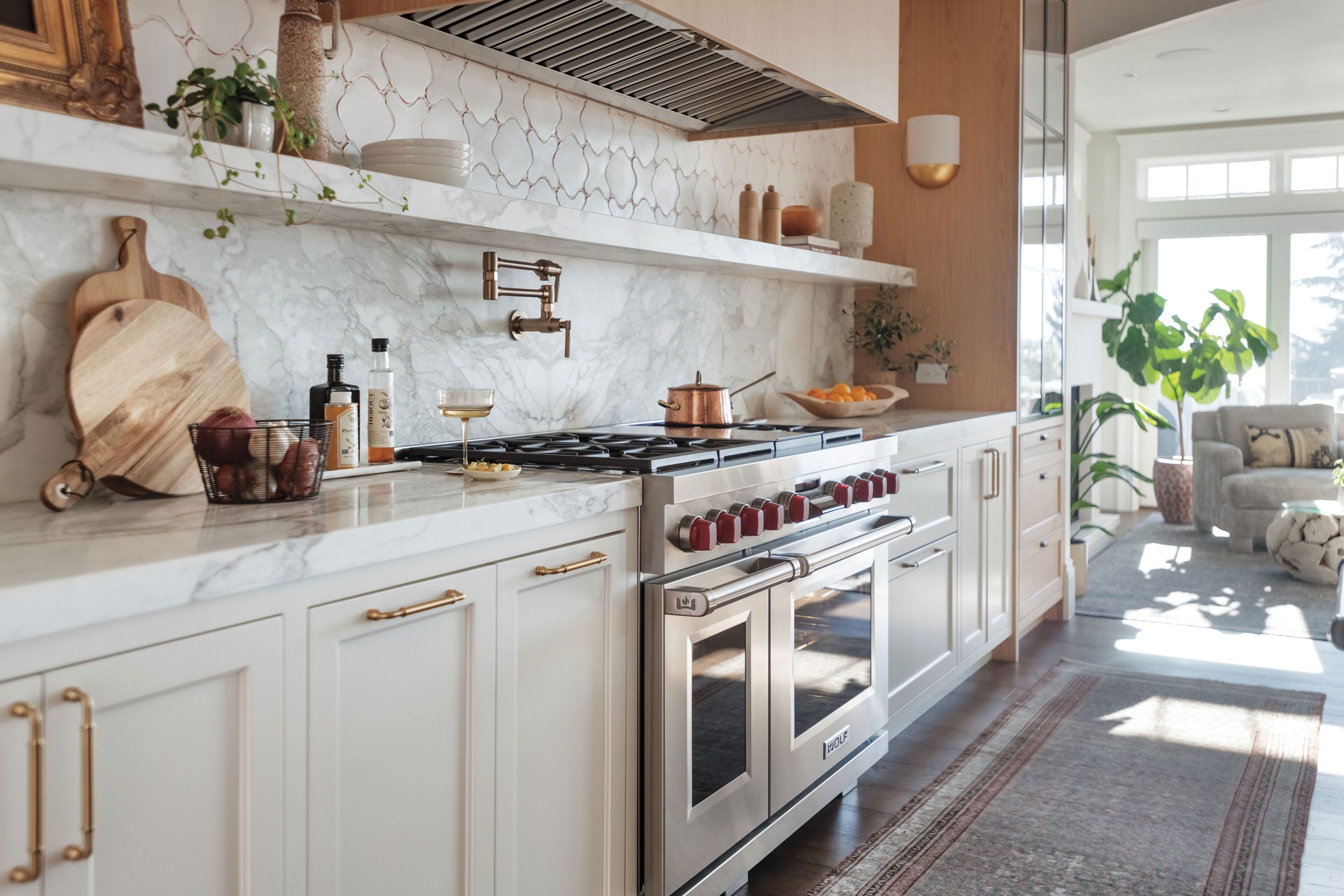 Image may contain: Indoors, Interior Design, Kitchen, Home Decor, Rug, Plant, Cooktop, Couch, Furniture, Lamp, and Sink