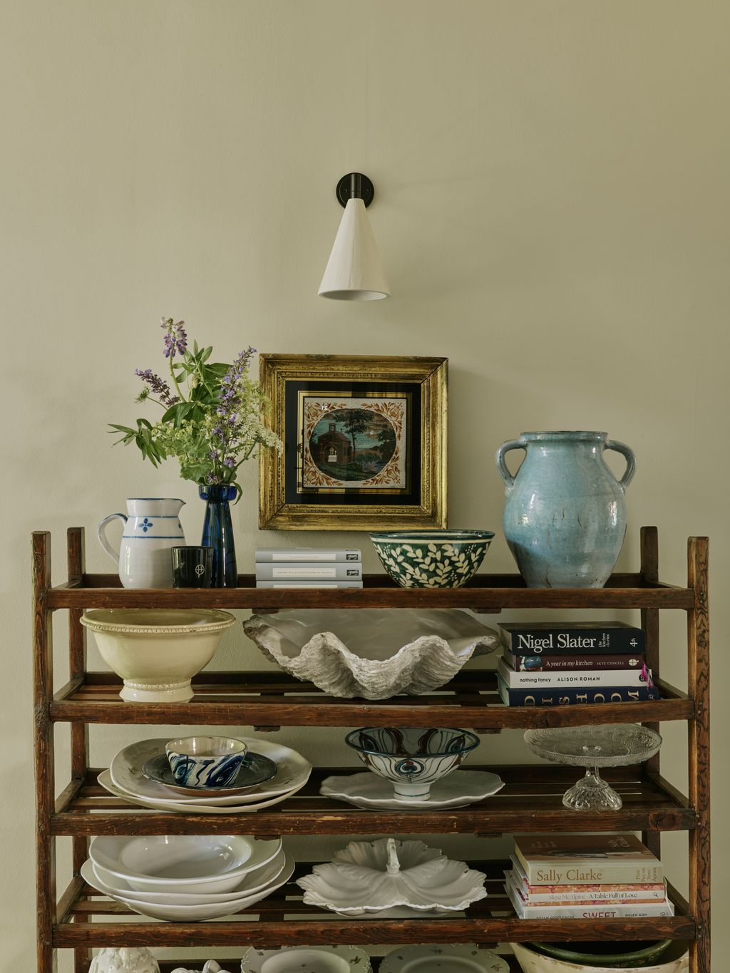 Image may contain Shelf Furniture Art Painting Cup Lamp Plate Indoors Interior Design Bookcase Pottery and Flower