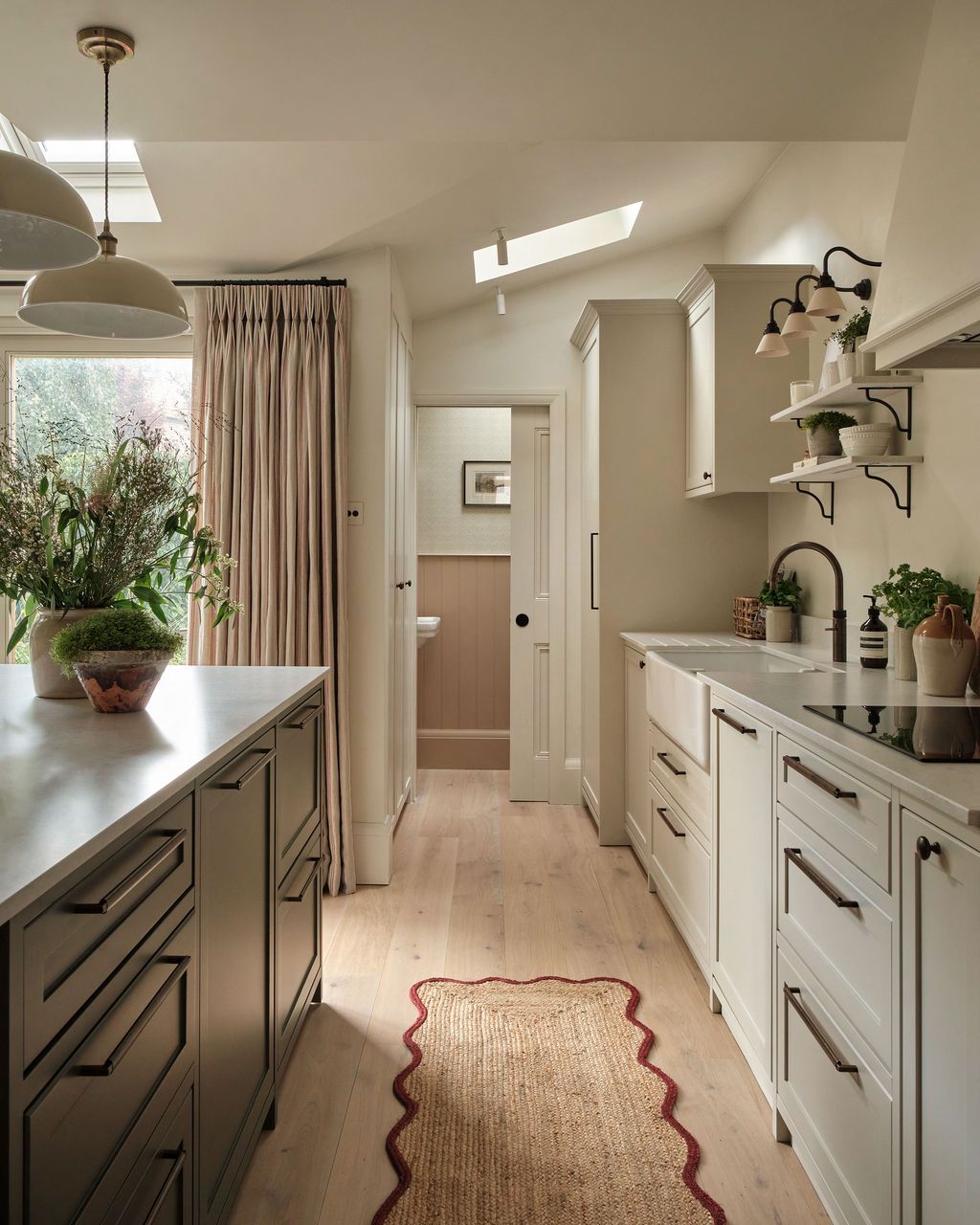 Image may contain Home Decor Lamp Plant Indoors Interior Design Rug Sink Sink Faucet Kitchen Art and Painting