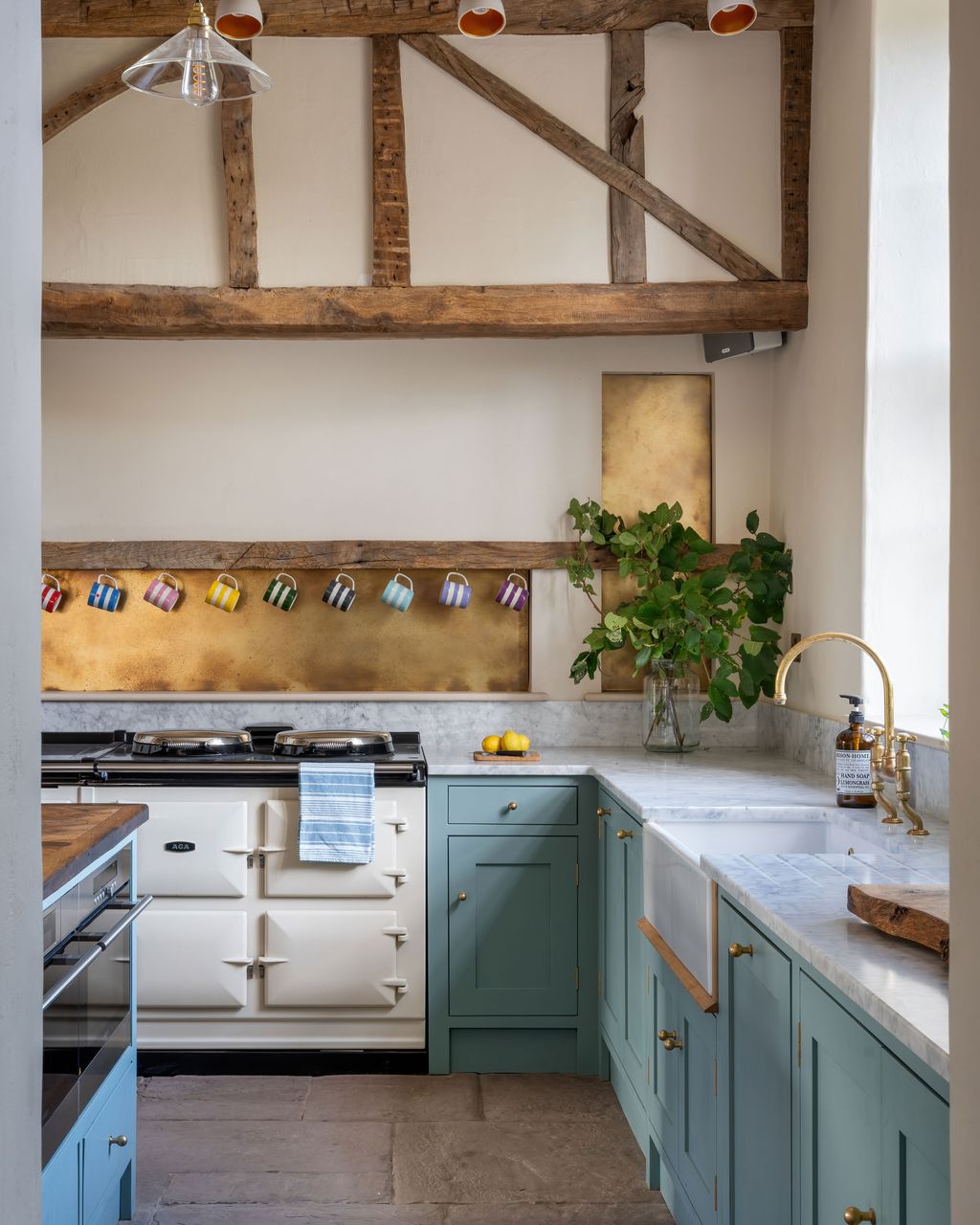 Image may contain Indoors Interior Design Kitchen Cup Sink Sink Faucet Plant Cooktop and Lamp