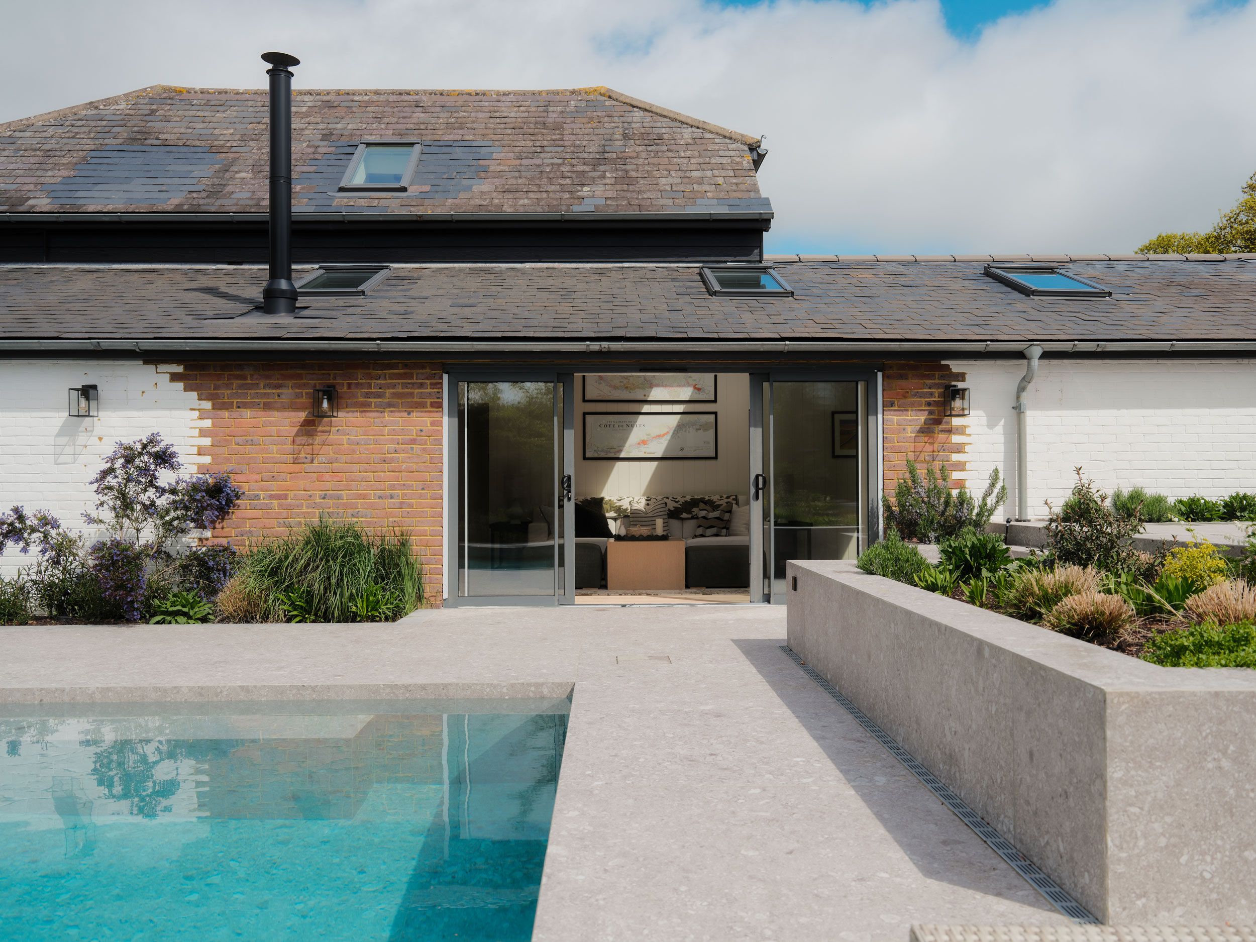 Image may contain: Lamp, Pool, Water, Art, Painting, Architecture, Building, House, Housing, Villa, Swimming Pool, and Door