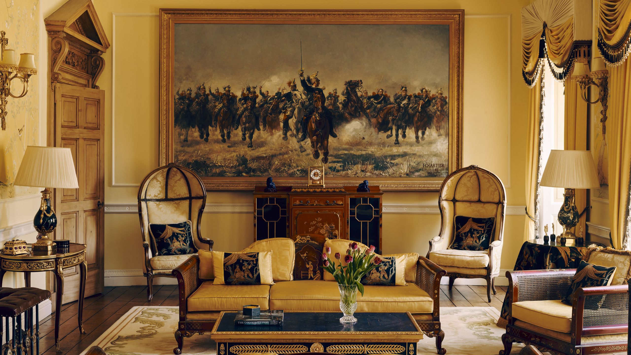 Image may contain: Home Decor, Architecture, Building, Furniture, Indoors, Living Room, Room, Lamp, Art, Painting, and Chair