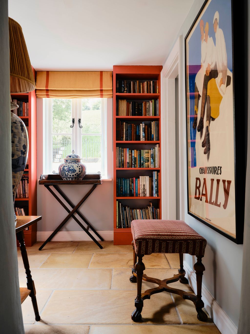 Image may contain Furniture Desk Table Lamp Bookcase Art and Painting