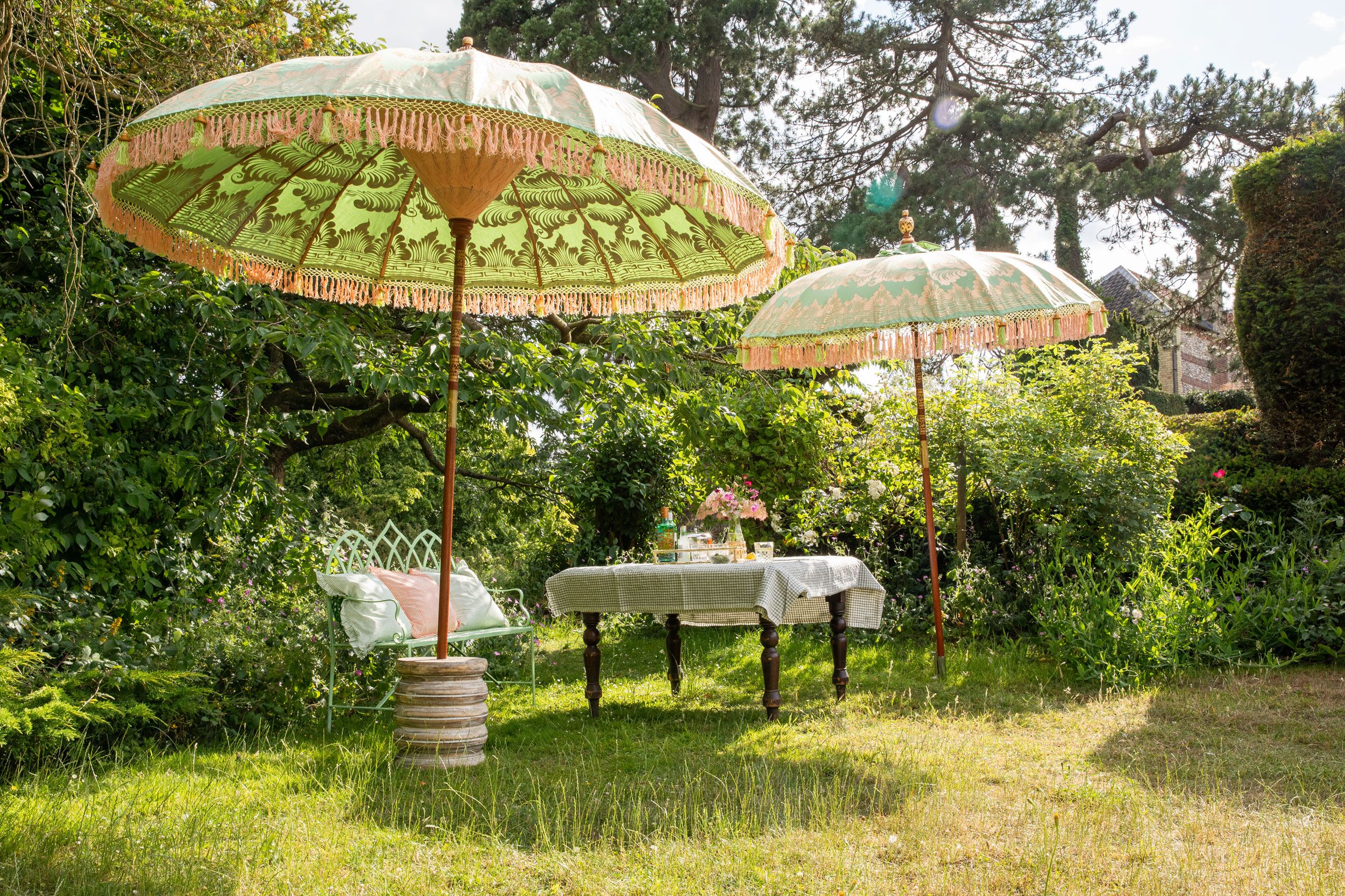 Image may contain: Grass, Plant, Desk, Furniture, Table, Architecture, Building, House, Housing, Patio, and Patio Umbrella