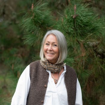 Image may contain: Adult, Person, Accessories, Jewelry, Necklace, Face, Happy, Head, Smile, Plant, Tree, and Photography