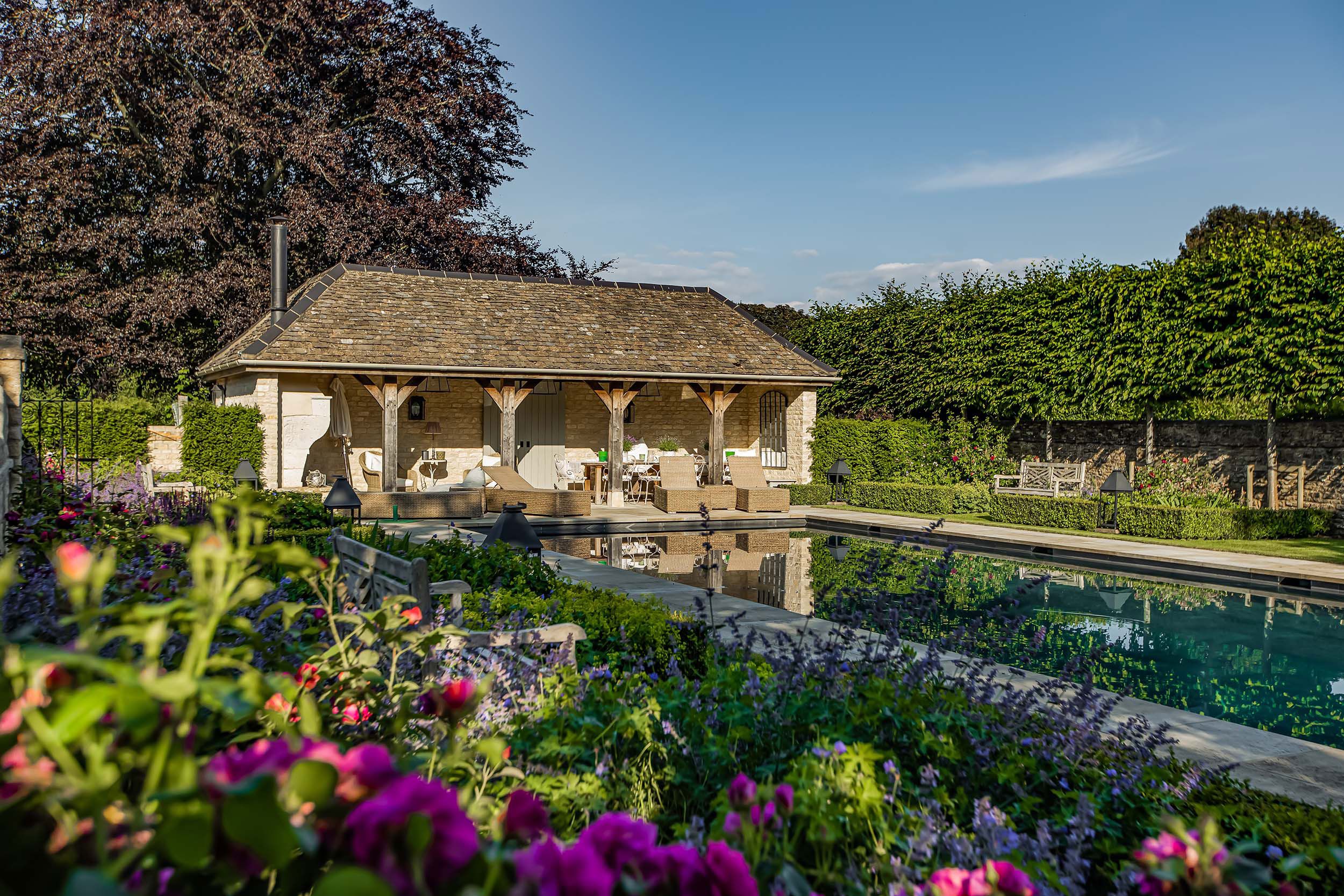 Image may contain: Architecture, Building, House, Housing, Villa, Cottage, Pool, Water, Bench, Furniture, Garden, and Nature