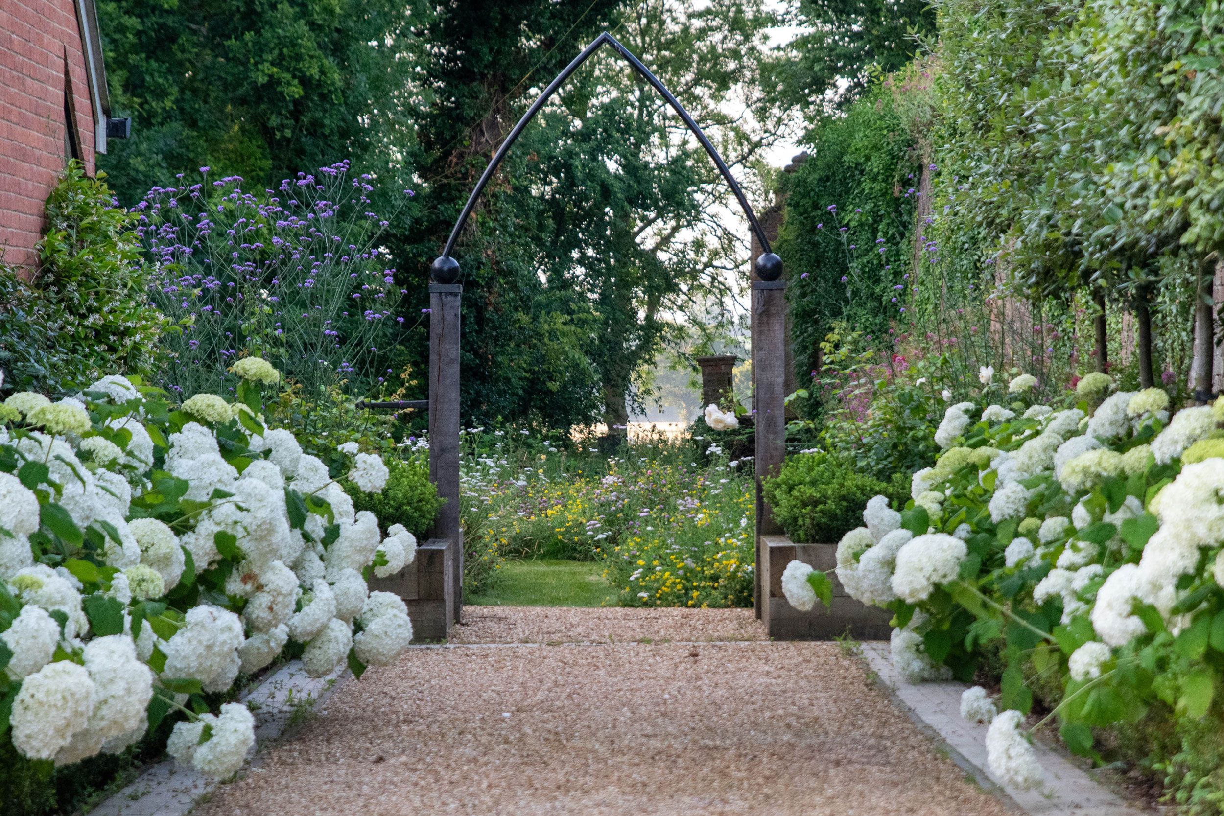 Image may contain: Garden, Nature, Outdoors, Grass, Park, Plant, Arbour, Vegetation, Architecture, Building, and Housing