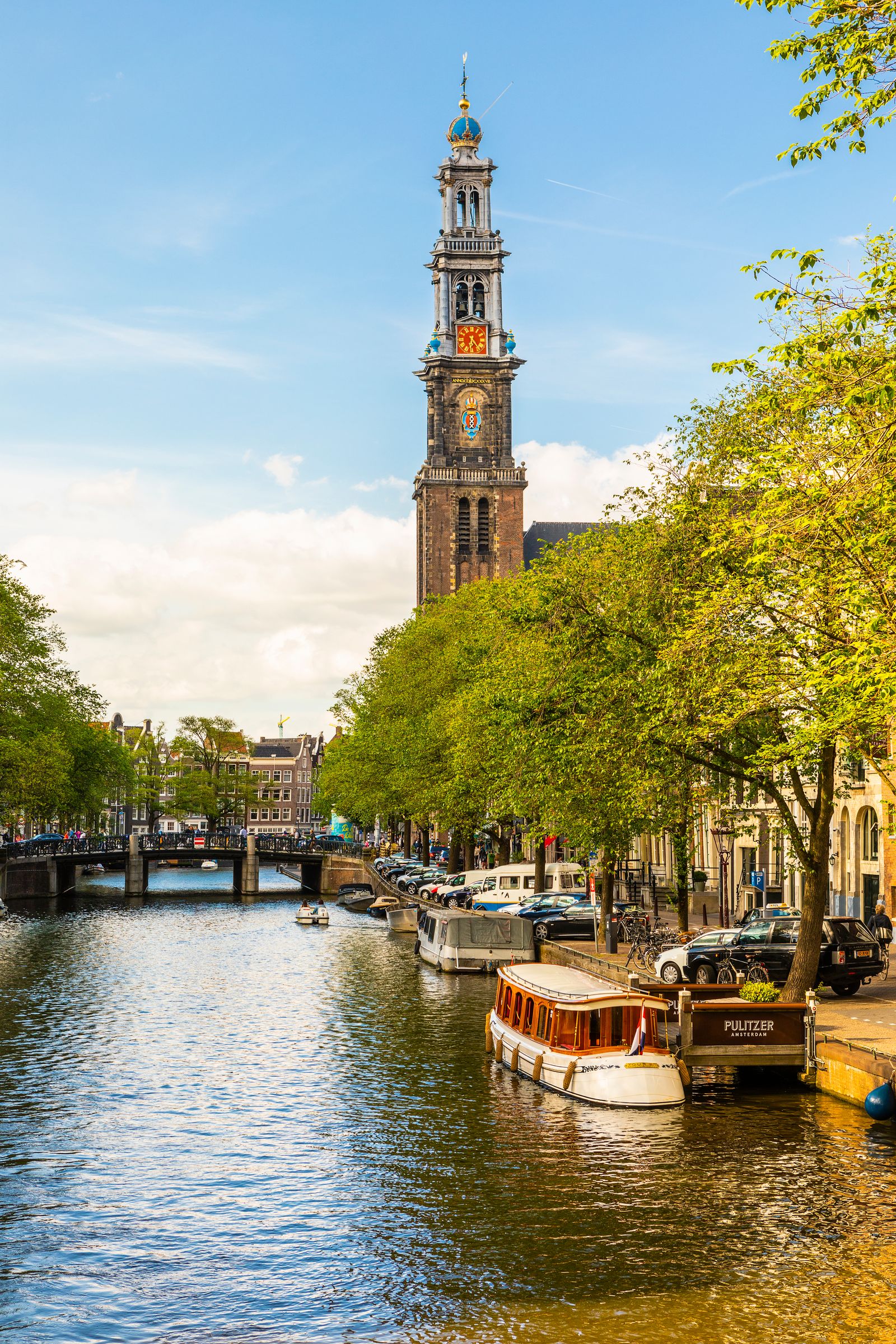 Image may contain Architecture Building Clock Tower Tower Bell Tower Boat Transportation Vehicle Car and Person