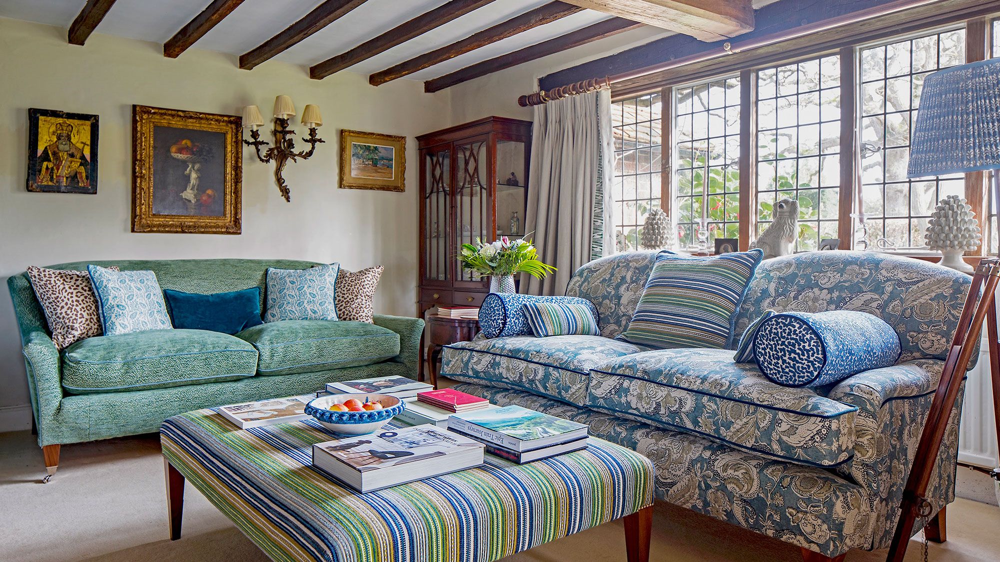 Image may contain: Book, Publication, Home Decor, Couch, Furniture, Art, Painting, Plant, Lamp, and Table