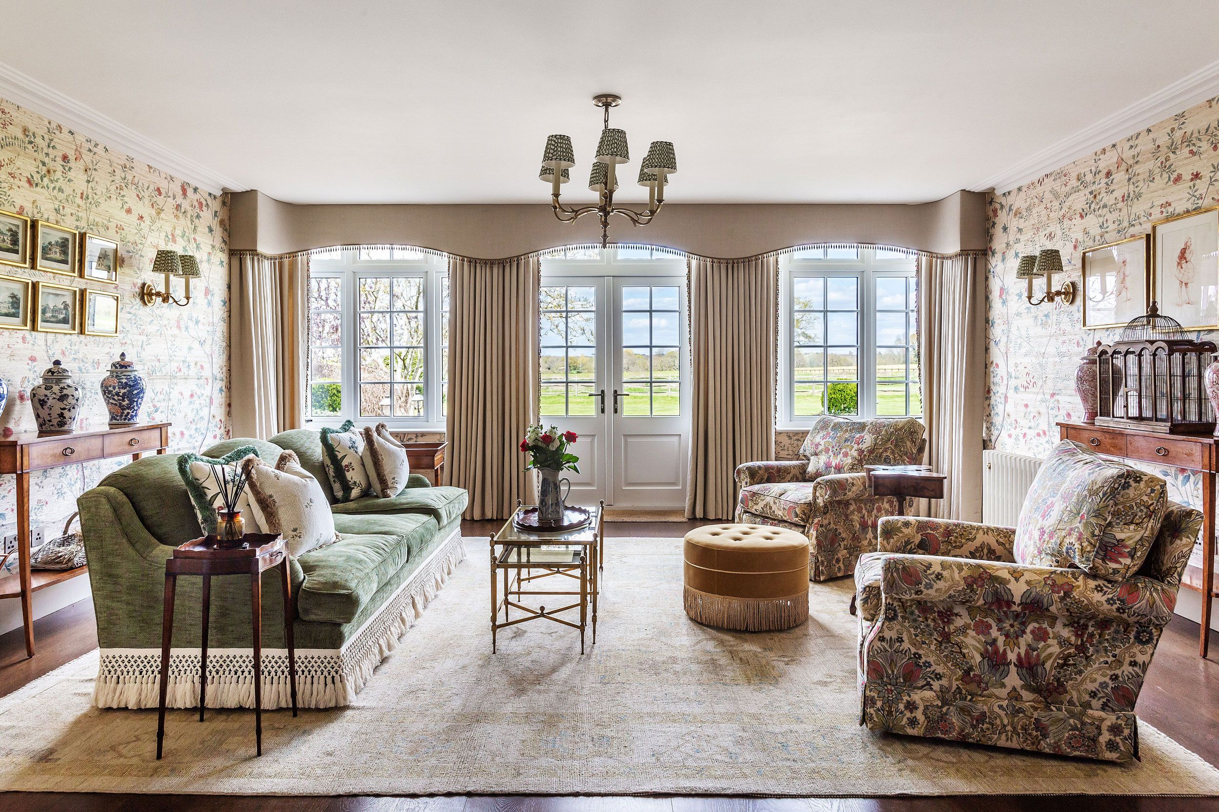 Image may contain: Home Decor, Lamp, Couch, Furniture, Rug, Art, Painting, Window, French Window, Desk, and Table