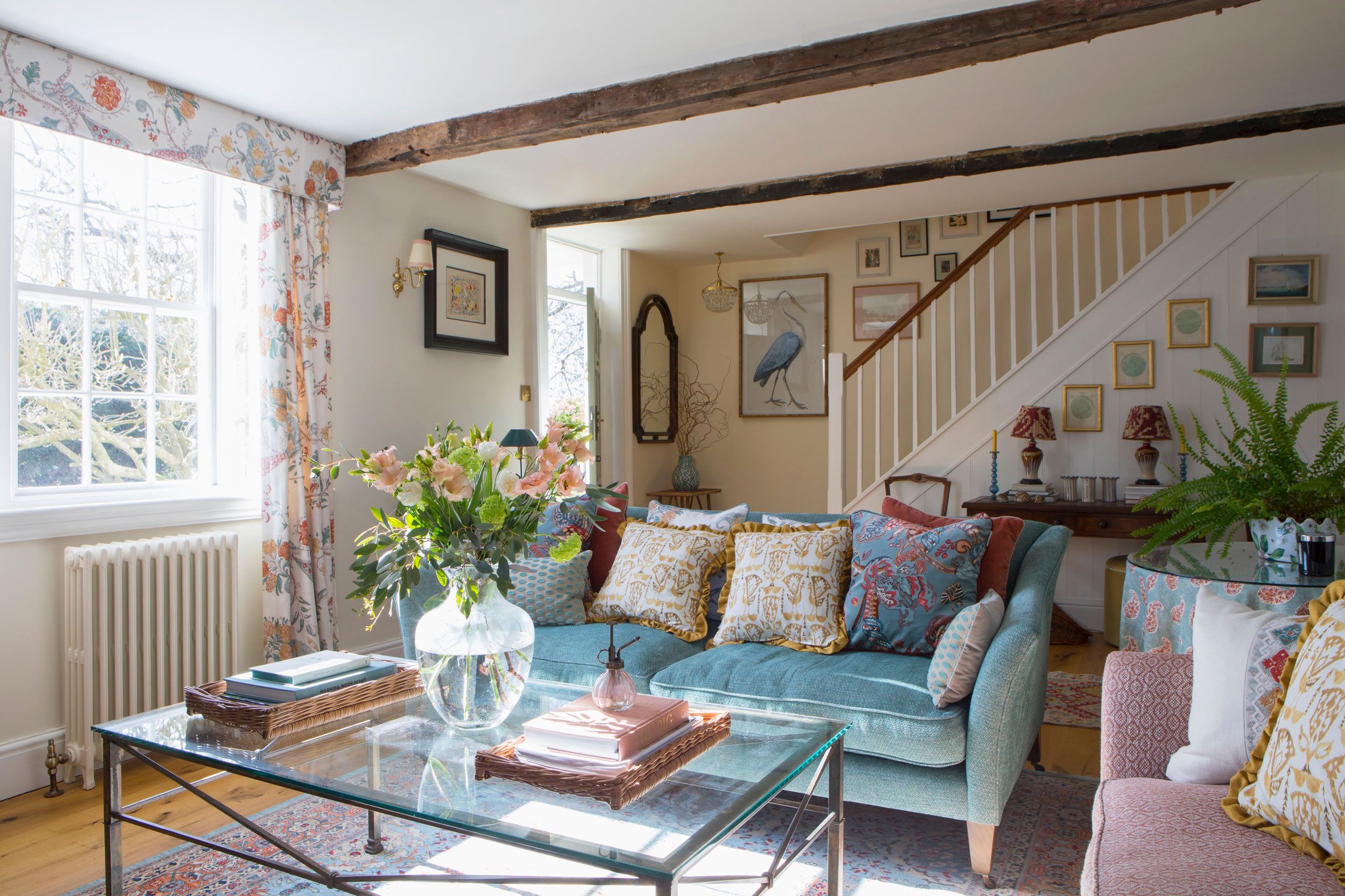 Image may contain: Home Decor, Architecture, Building, Furniture, Indoors, Living Room, Room, Lamp, Table, Plant, and Couch