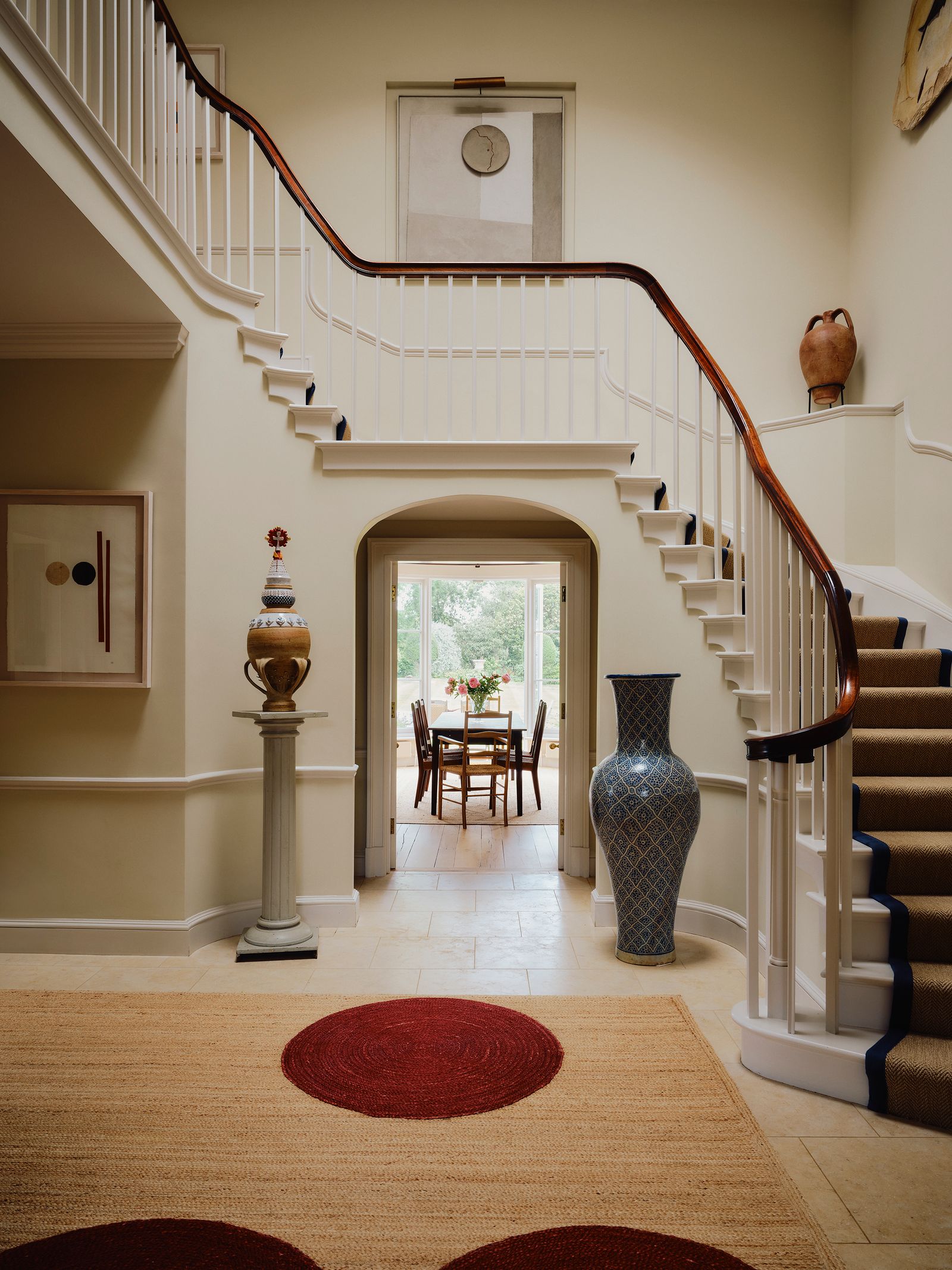 Image may contain Architecture Building Foyer Indoors Home Decor Rug Chair Furniture Desk Table House and Housing