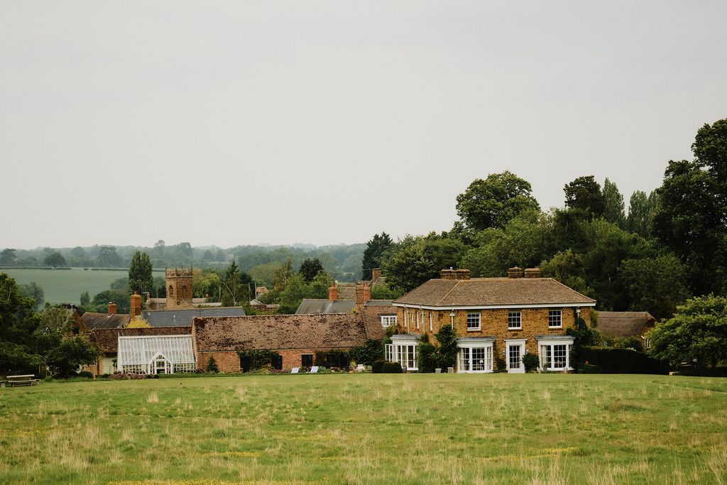 Image may contain Nature Outdoors Countryside Rural Farm Field Pasture Village Bench Furniture and Architecture
