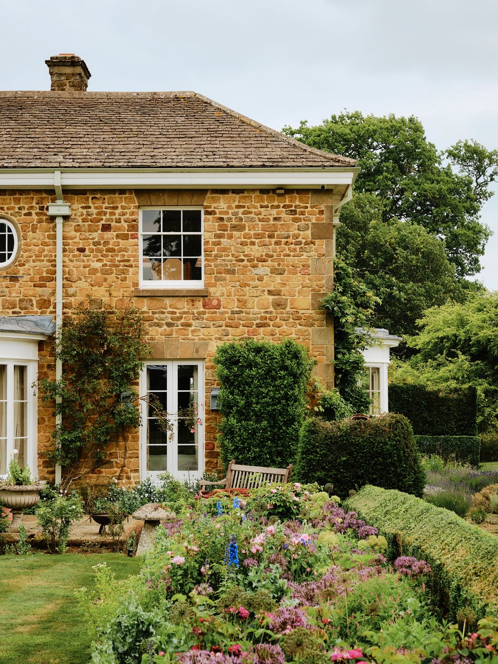 Image may contain Architecture Building Cottage House Housing Bench Furniture Plant Grass Outdoors and Nature