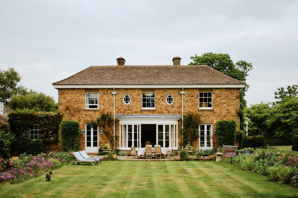 Image may contain Architecture Building Housing House Manor Bench Furniture Cottage Chair Grass Plant and Animal