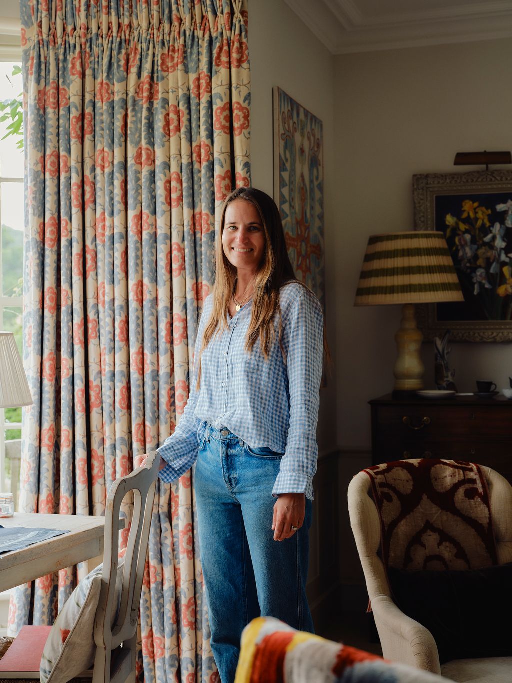 Image may contain Clothing Pants Lamp Jeans Adult Person Art Painting Cup Accessories Jewelry Necklace and Couch