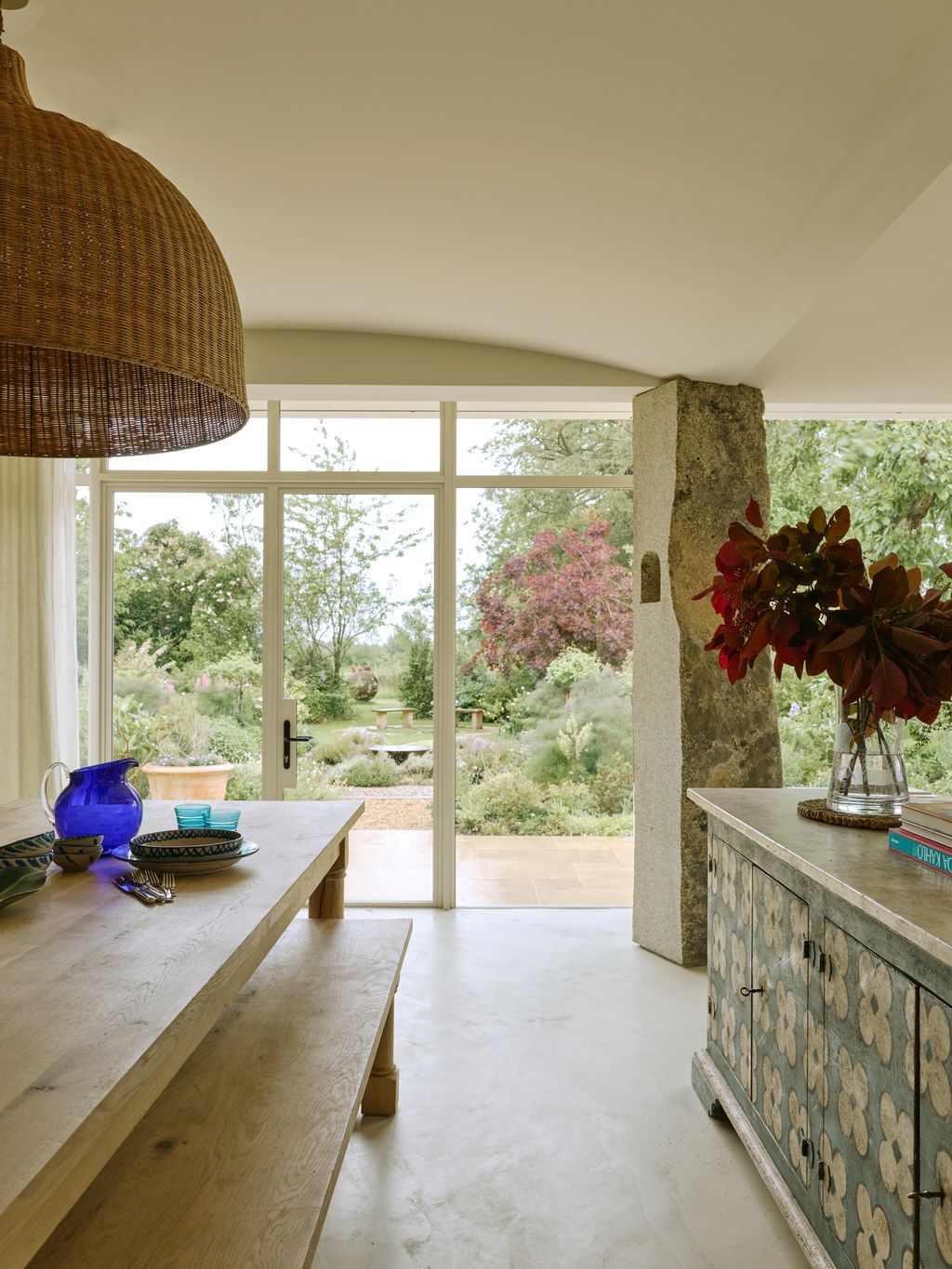 Image may contain Indoors Interior Design Lamp Desk Furniture Table Floor Bench Window French Window and Plant