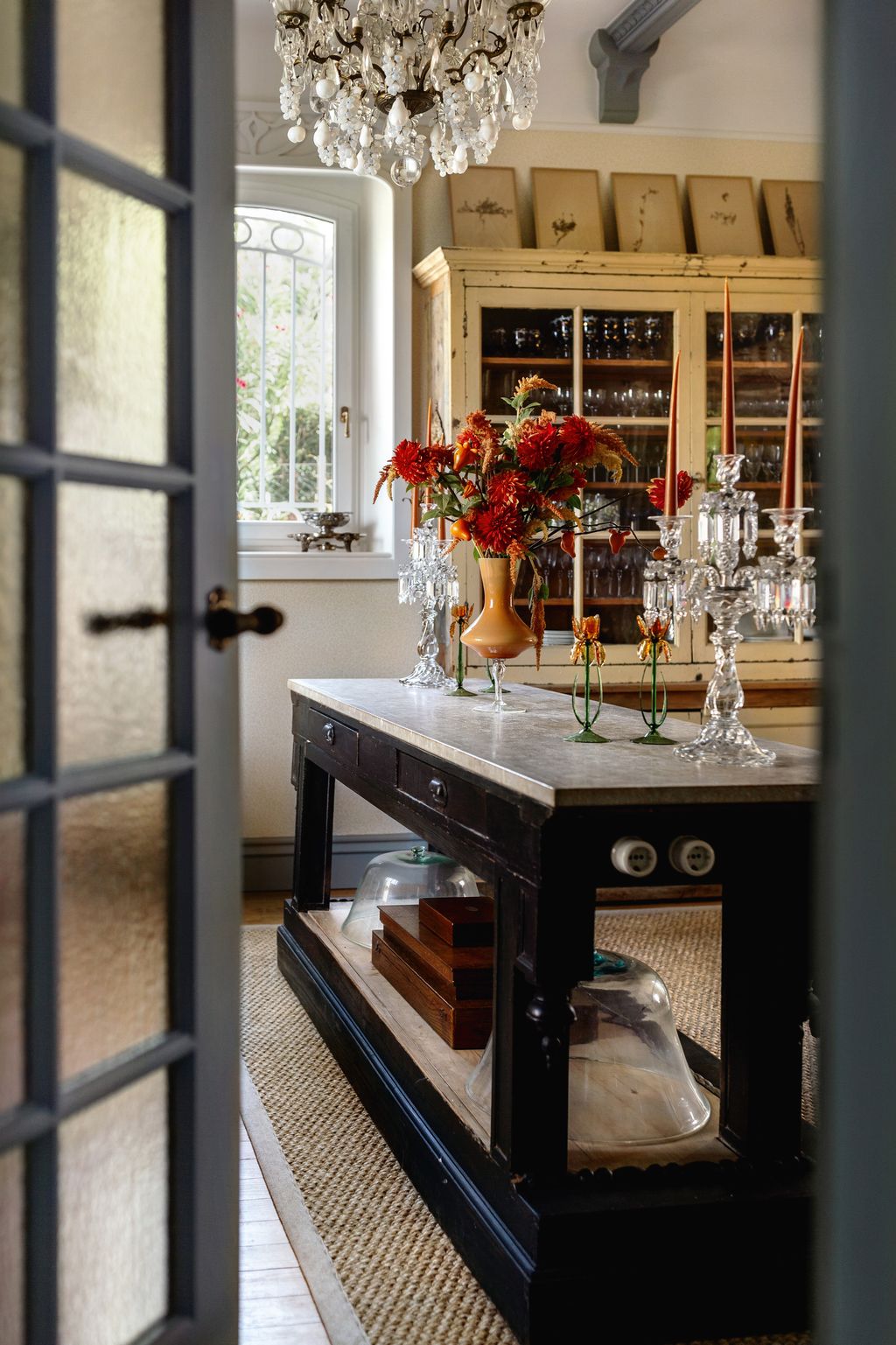 Image may contain Lamp Door Chandelier Architecture Building Housing Flower Flower Arrangement Plant and Art