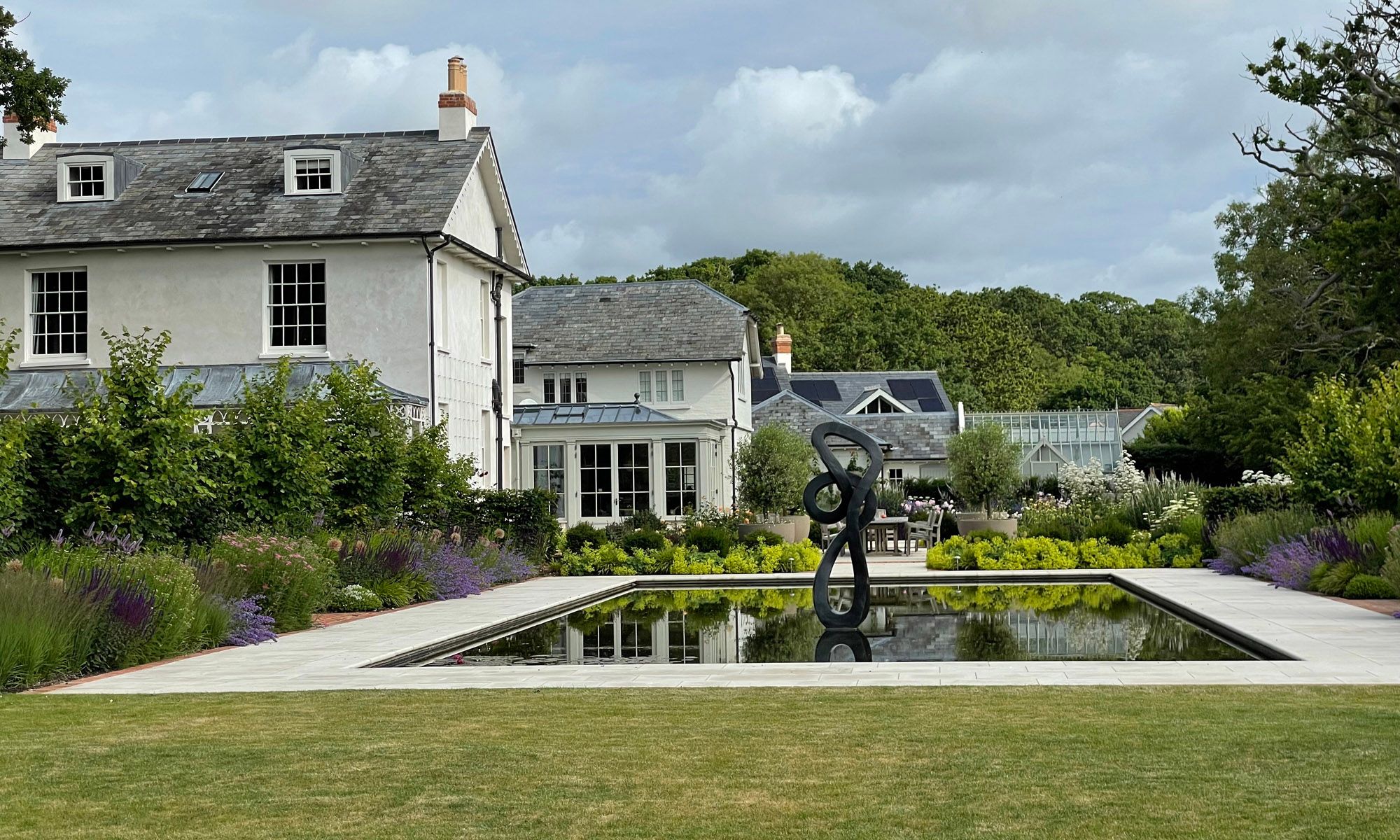 Image may contain: Plant, Architecture, Building, Housing, Grass, Outdoors, House, Manor, and Water