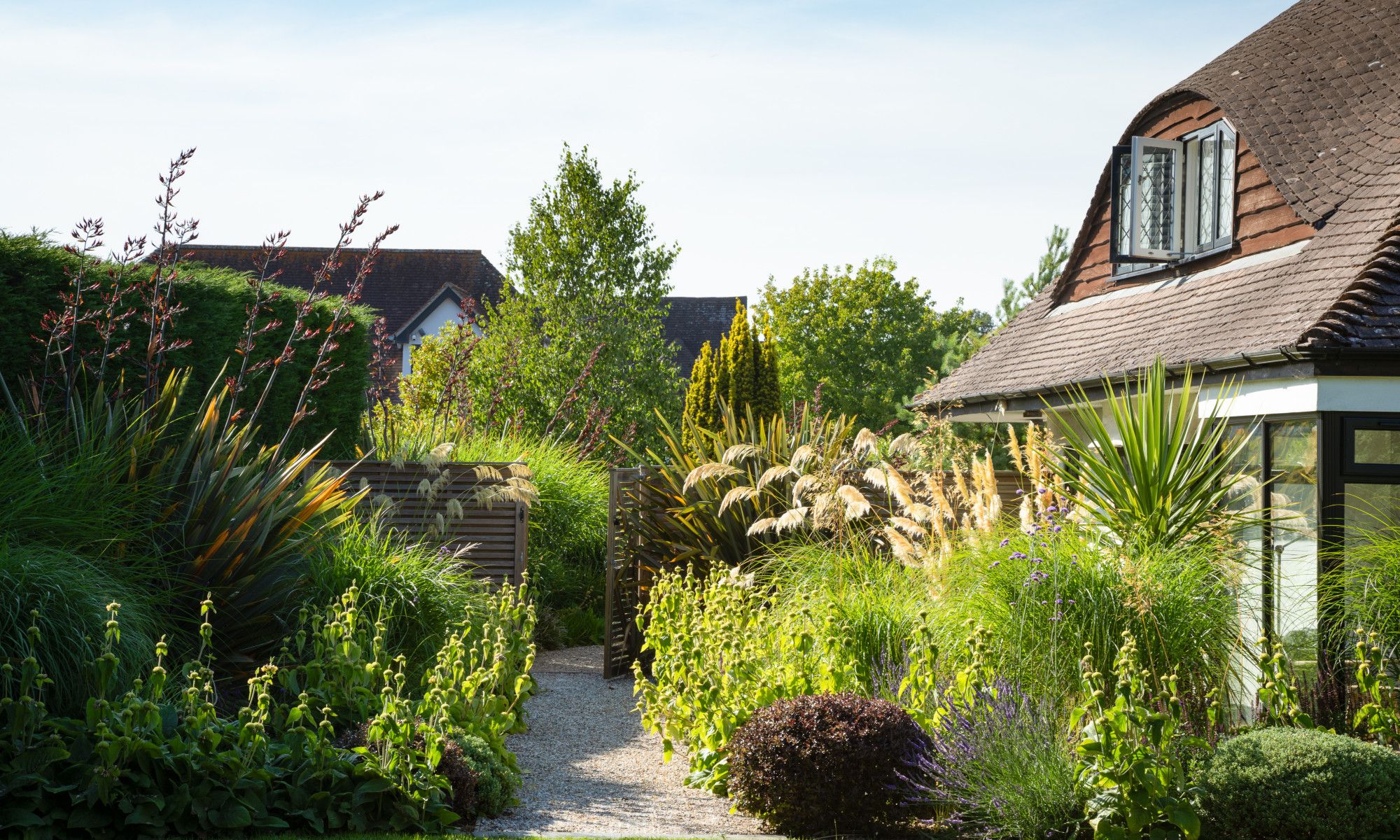 Image may contain: Architecture, Building, Cottage, House, Housing, Garden, Nature, Outdoors, Grass, Plant, and Vegetation